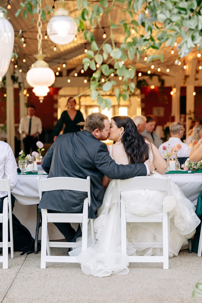 Bride and groom kissing during wedding reception, captured by Lorissa Lee Photography. Featured on Brontë Bride.