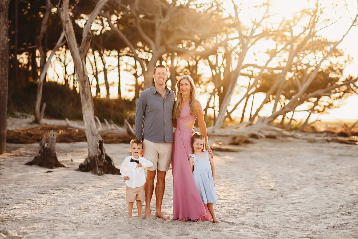 Family embraces each other during Family Portraits on Folly Beach. 