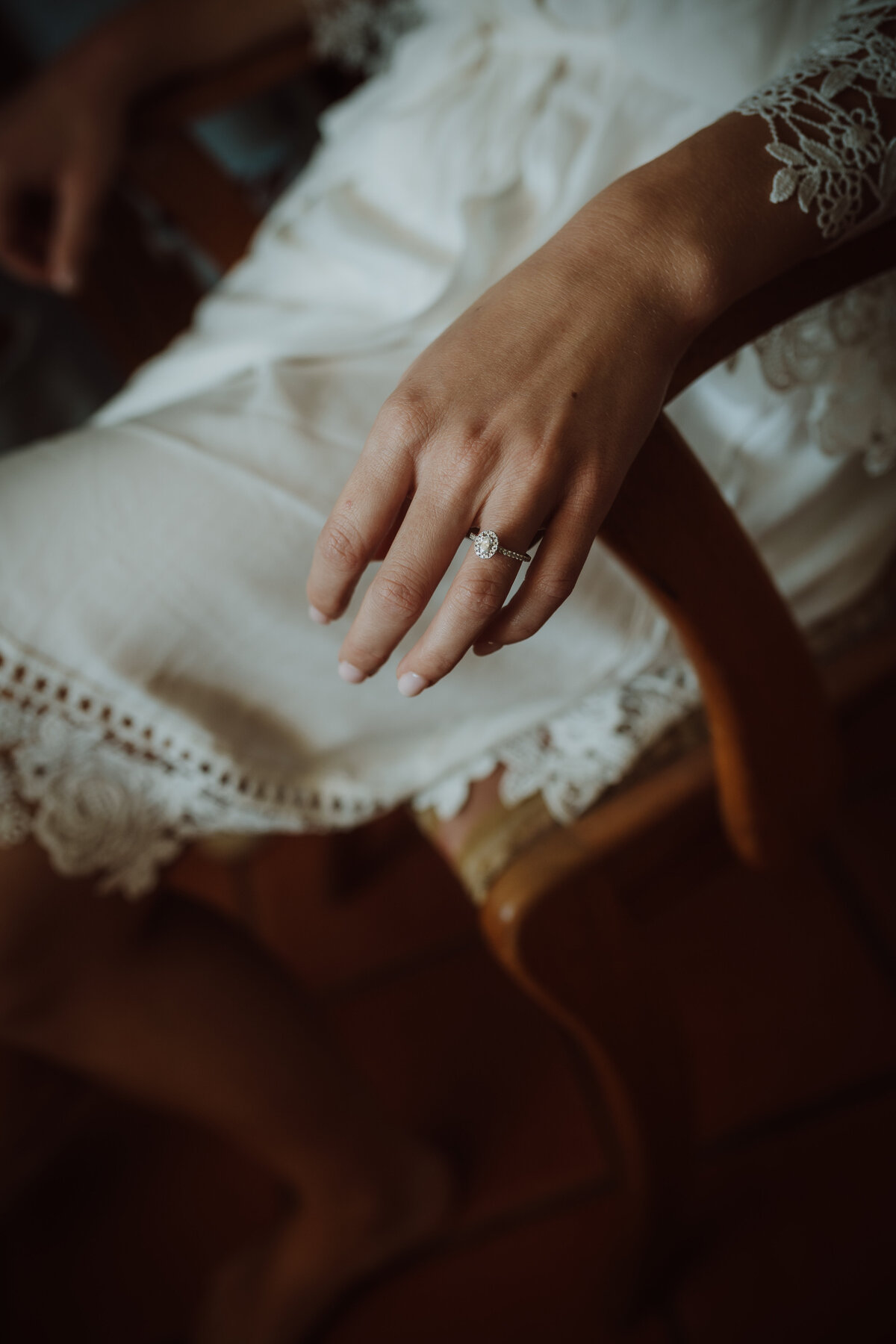 A bride's hand showing her engagement ring