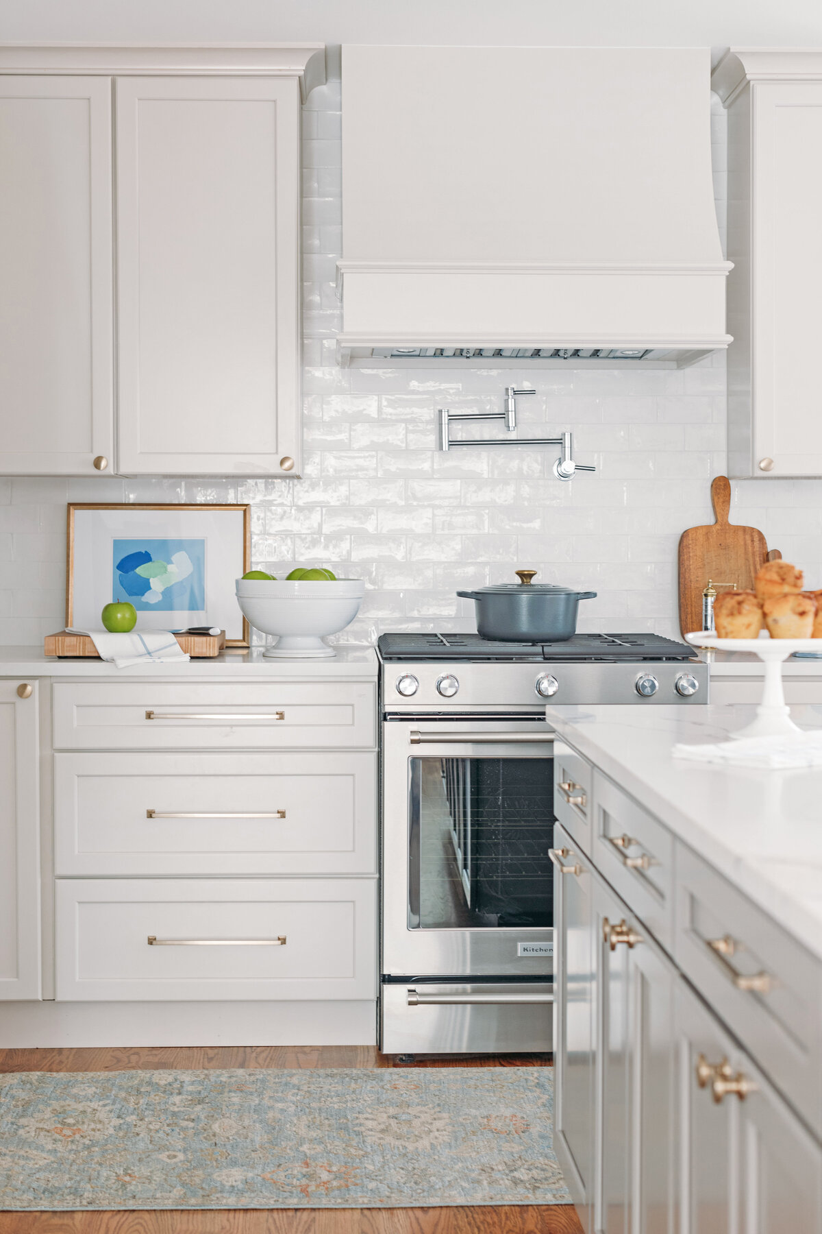 Fresh traditional kitchen renovation  with white cabinets and white subway backsplash