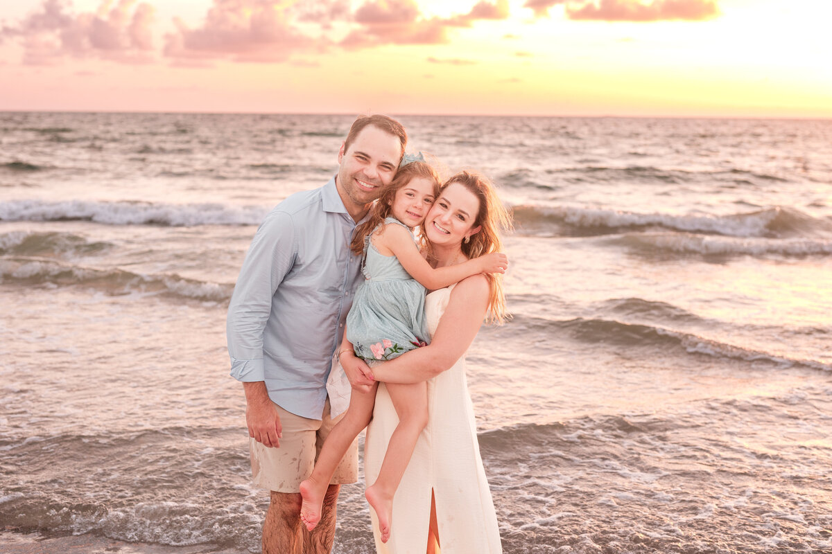 Candid family moments captured at Indian Rocks Beach by the waterline.