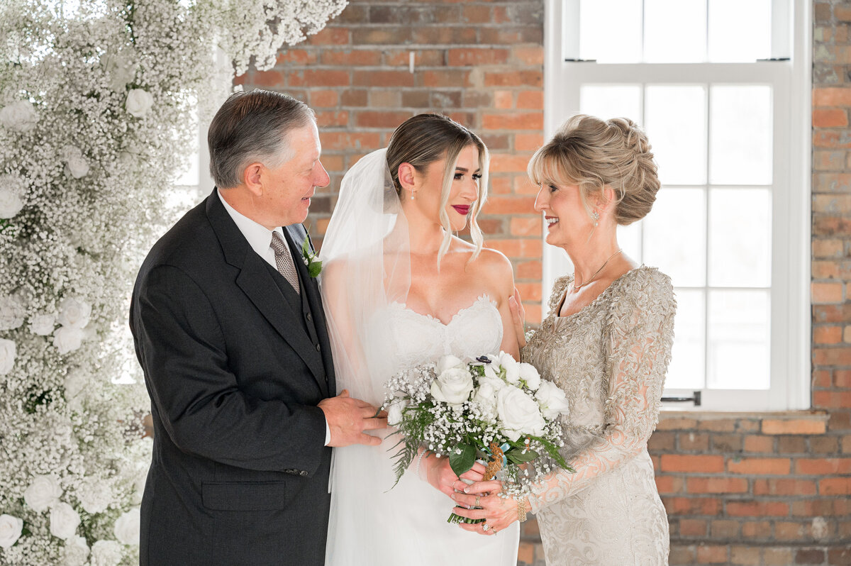 bride and parents looking at each other at pump house pittsburgh wedding