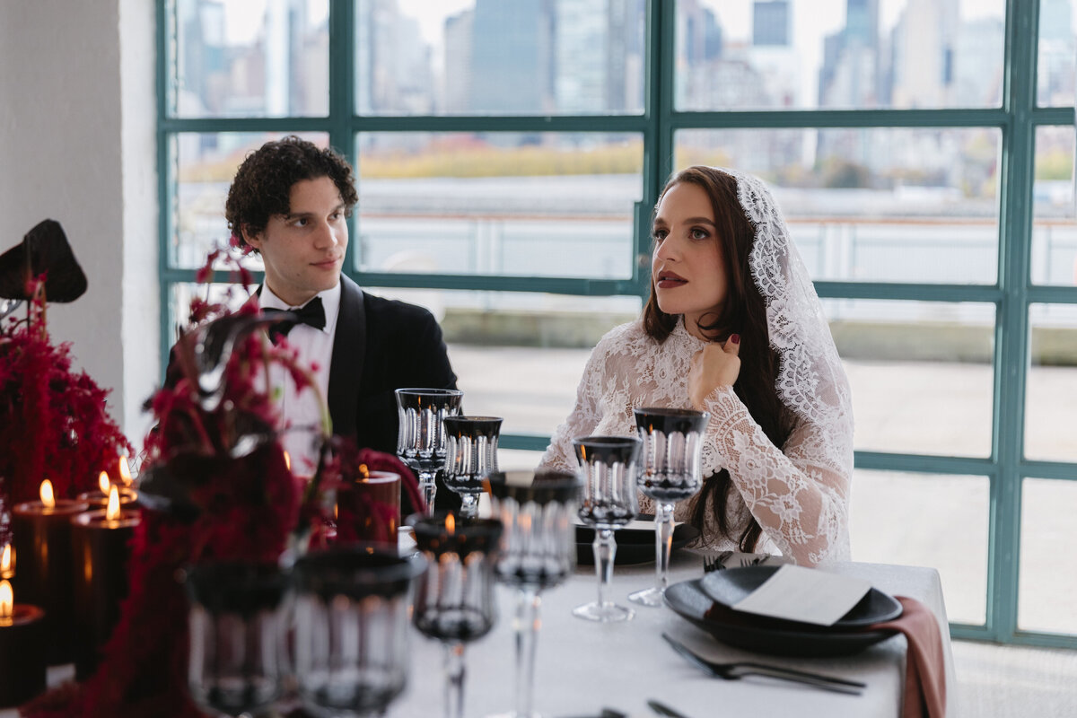 meredith-michel-editorial-wedding-couple-at-candlelit-table