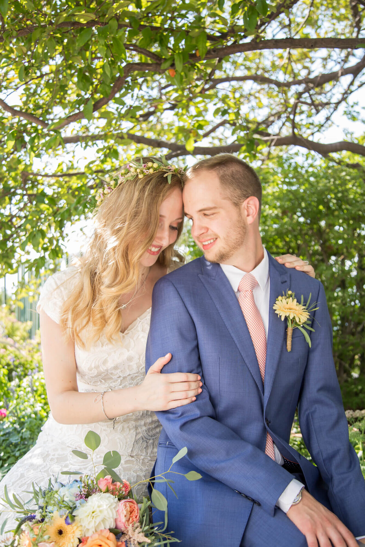 Bride and groom nestled under the shade of a tree, moment captured by Las Vegas wedding photography pro Jessica Bowles