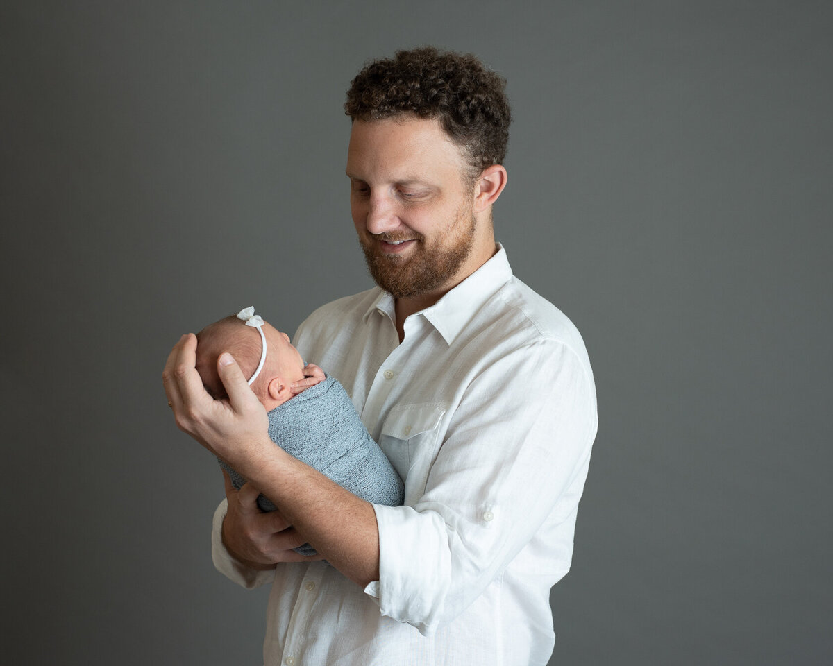 Newborn and Dad sweet moment captured by Laura King Photography