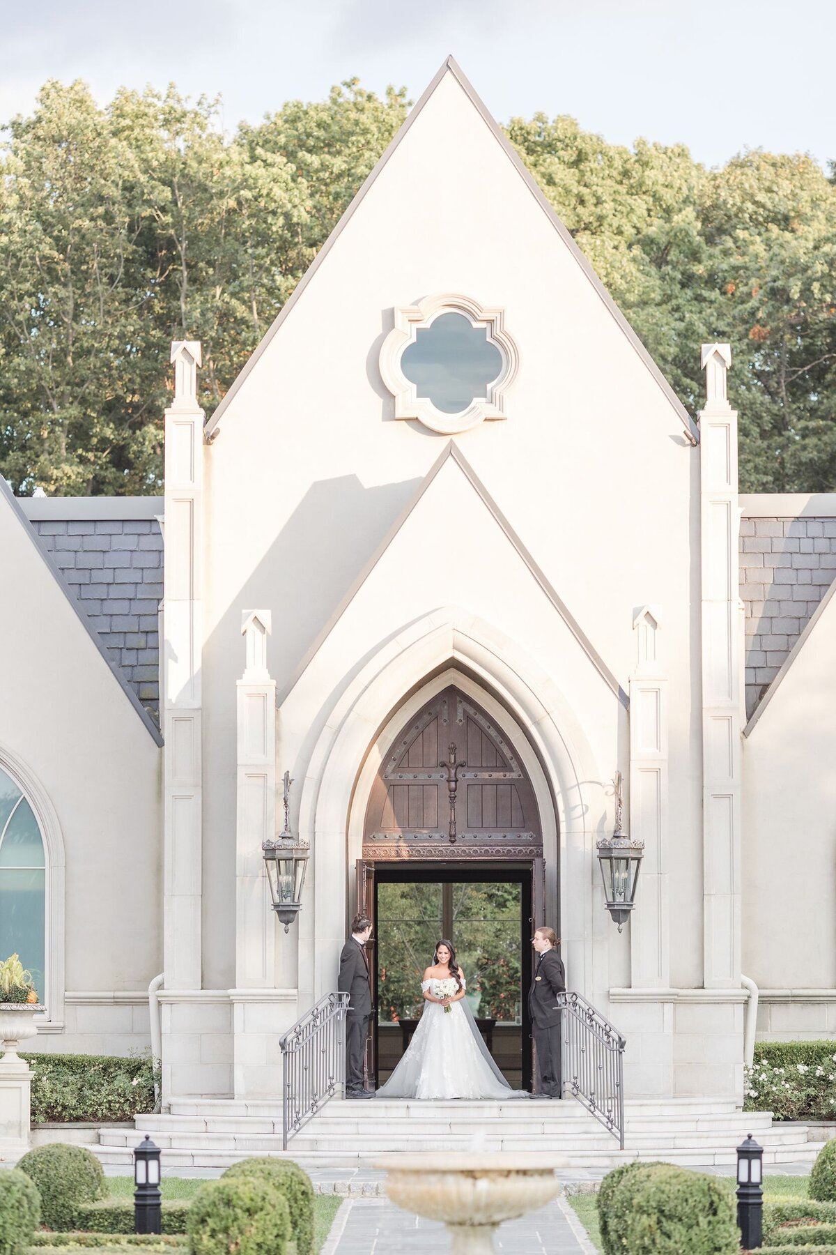 Bride exiting from grand church entrance