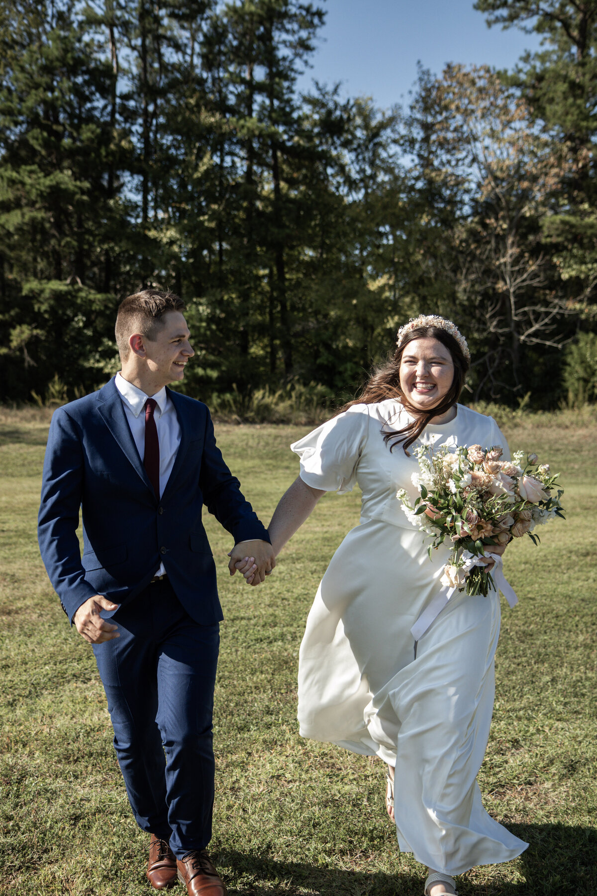 Bride and groom holding hands during their intimate wedding ceremony, deeply focused on their vows and the sacredness of their union.