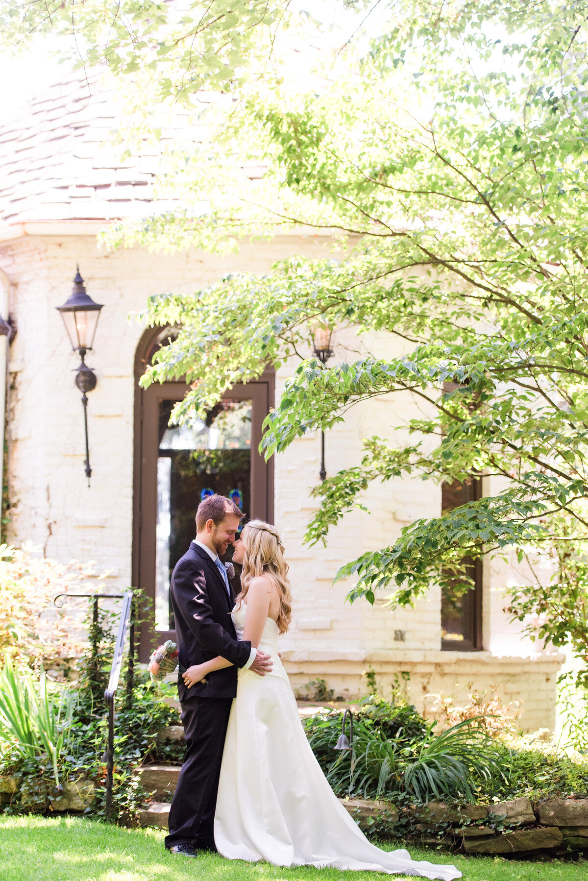 picture married couple in front of the Hyeholde restaurant on a sunny day