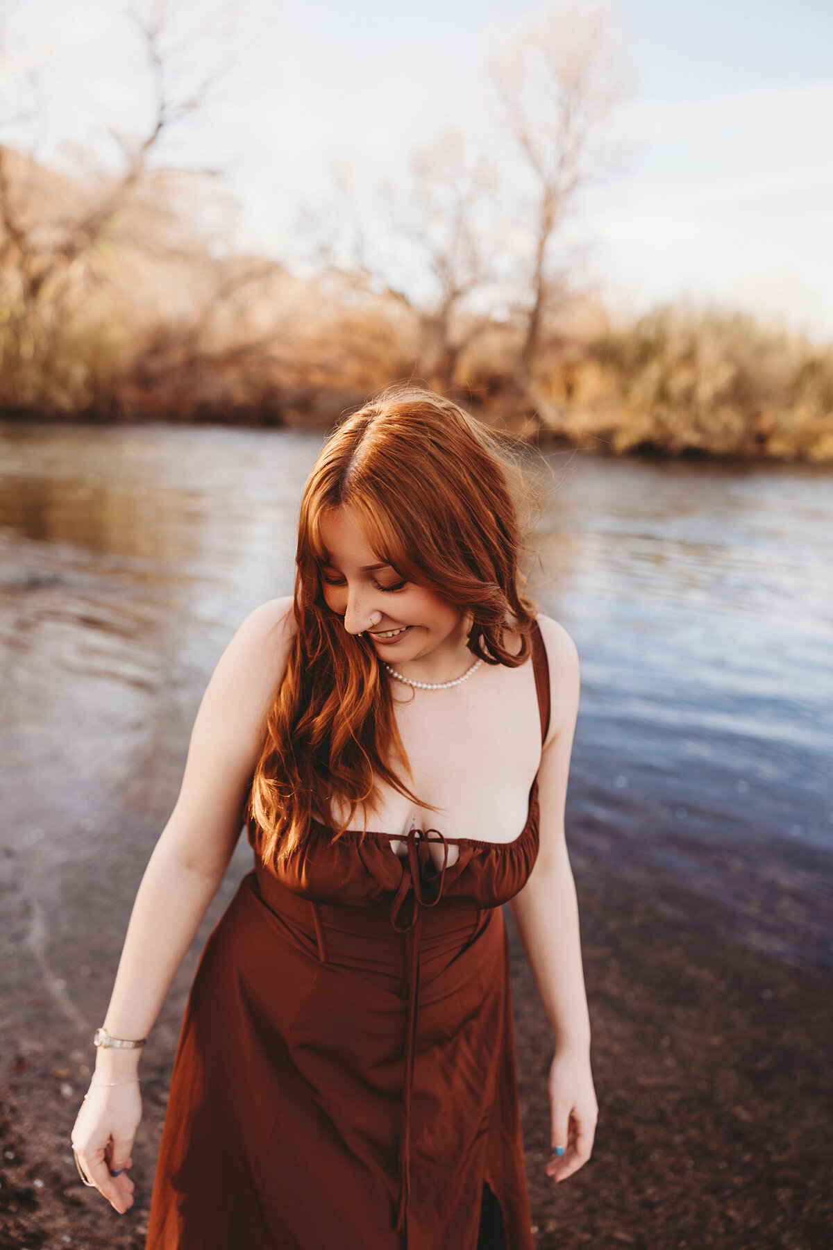 Girl with red hair posing at salt river for senior session by phoenix photographer