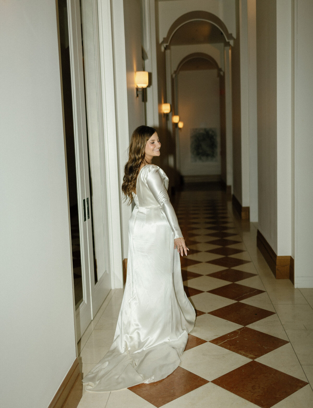 playful bride dances down Shinola Hotel hallway in Detroit, Michigan