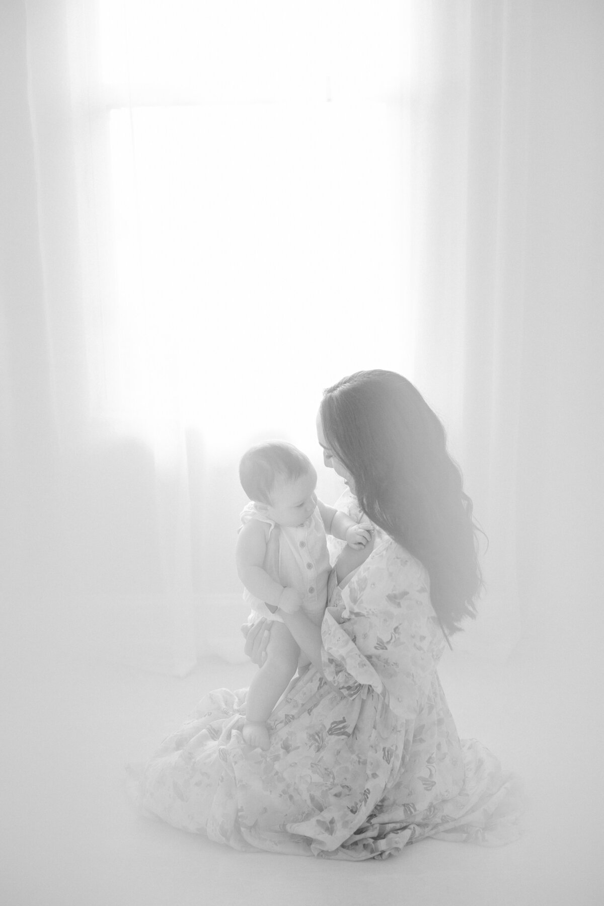 Tampa 6-month milestone black and white portrait of mom and baby boy in natural light studio