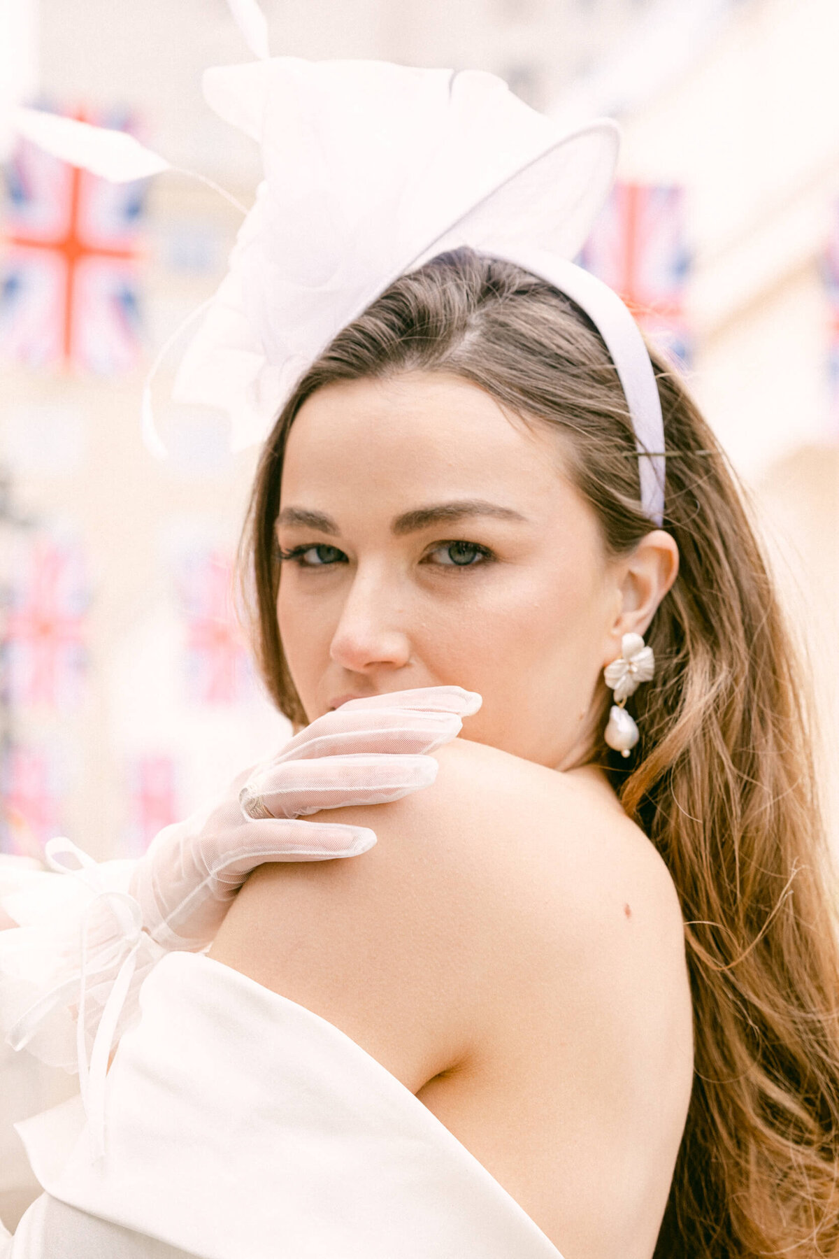 A wedding photo of the bride in her white wedding dress holding her white bouquet of flowers in London