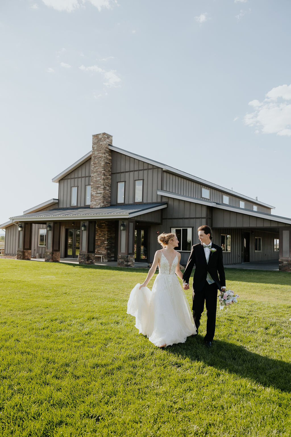 Couple walking across the lawn toward the barn