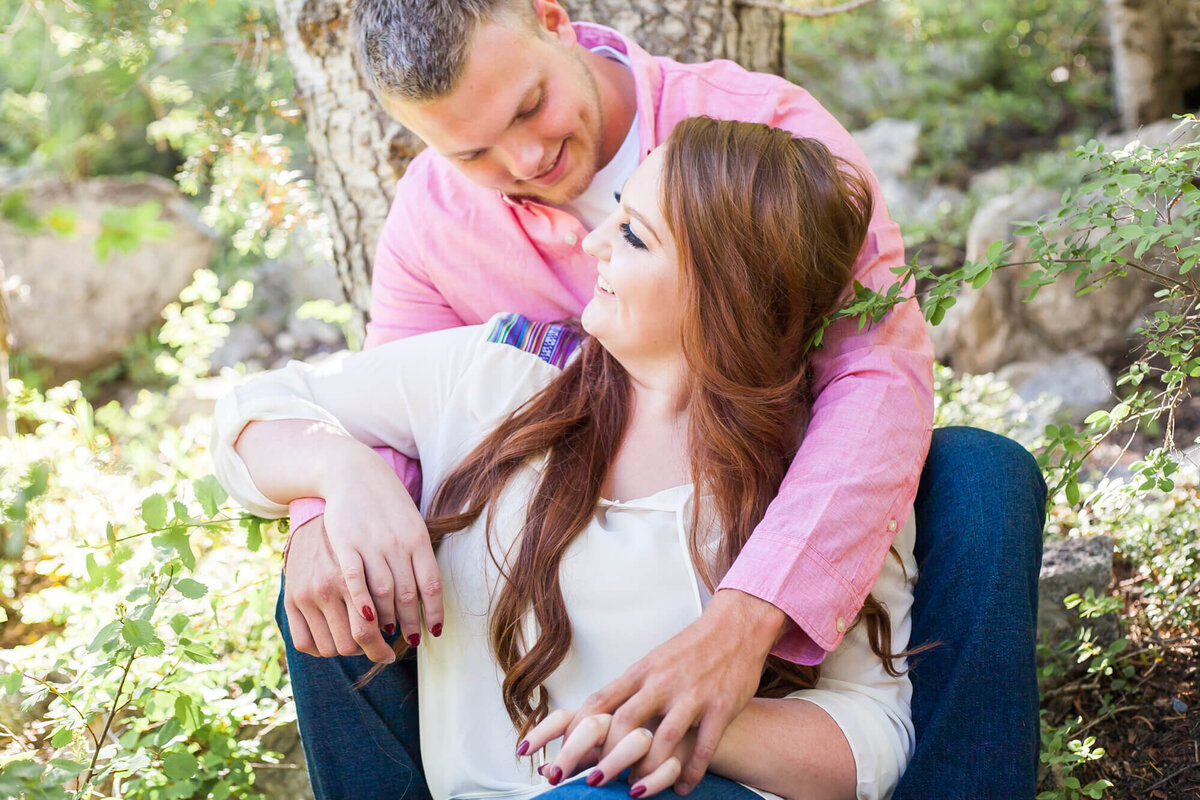 a engaged couple looking at each other during their mountain engagement session