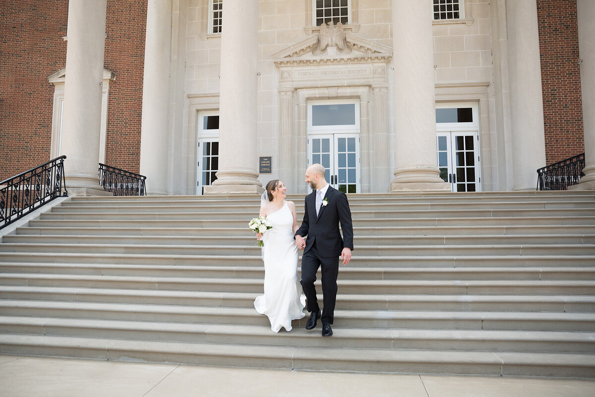 Wedding couple walks down stairs of Chicago History Museum