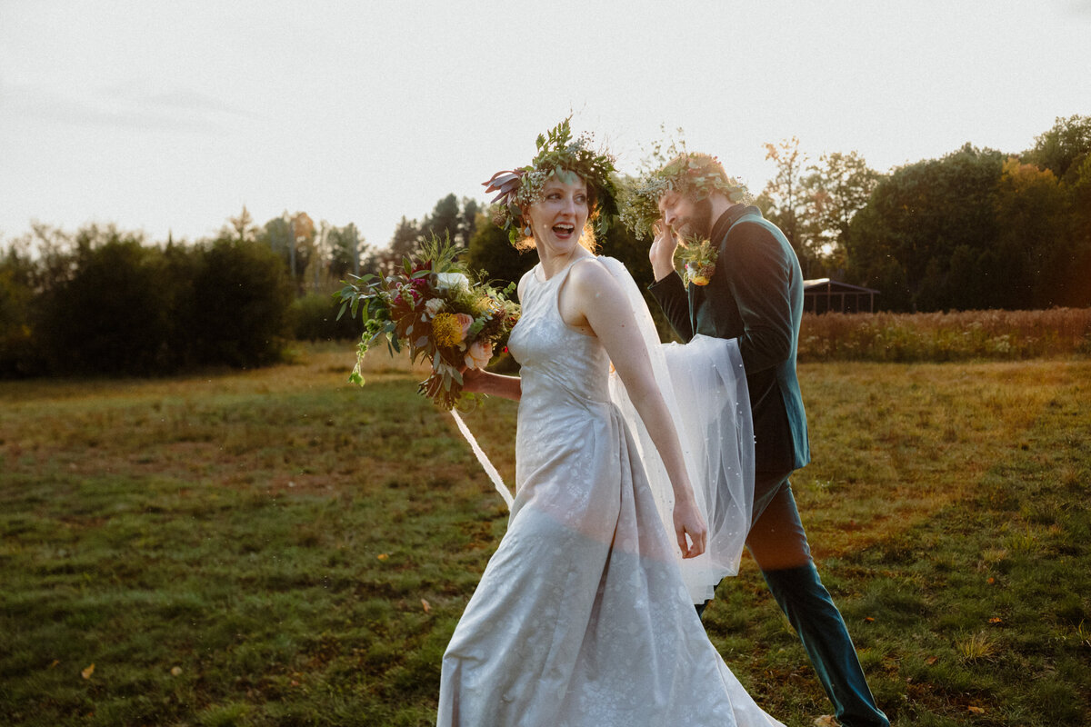 newlyweds walking in nature at sunset