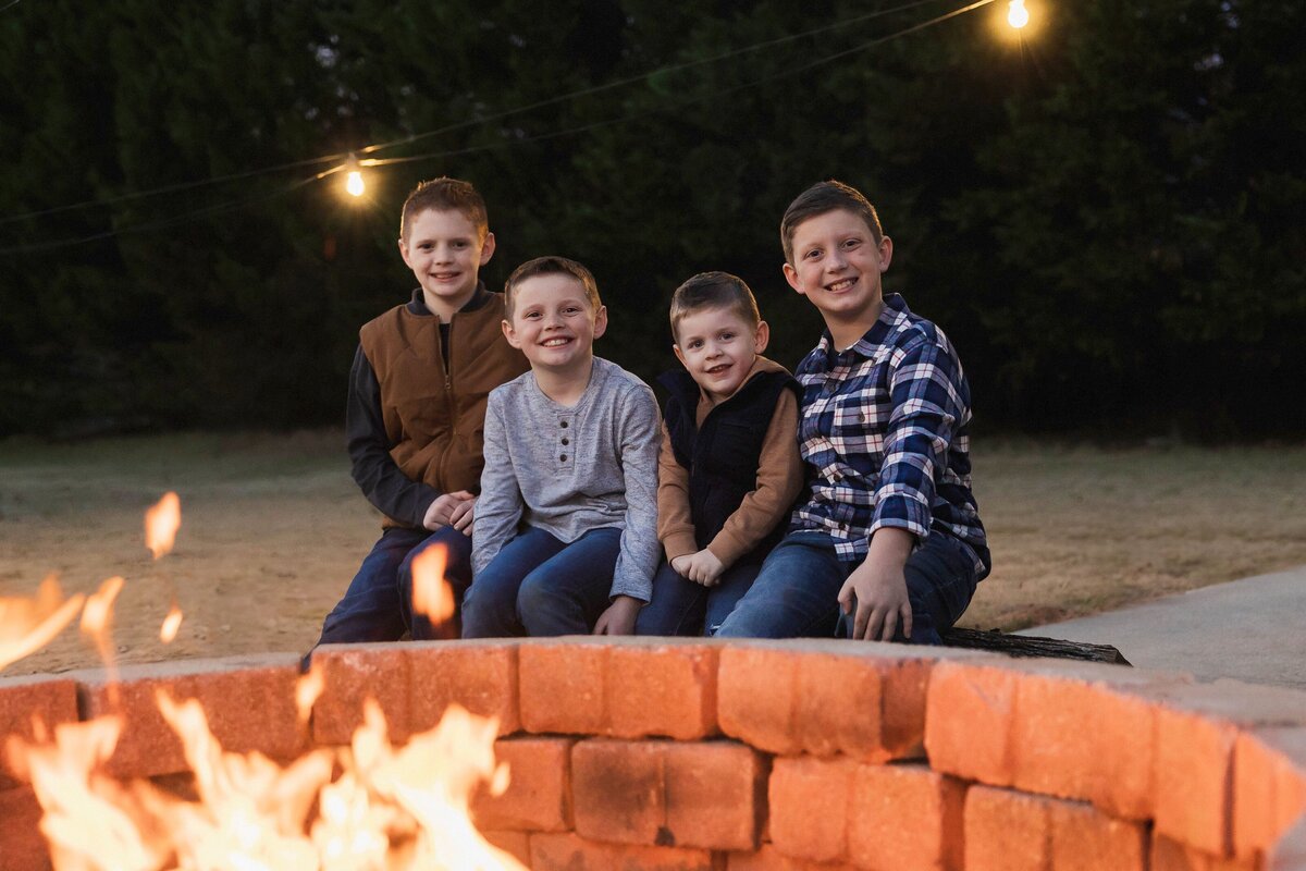 brothers sitting around a fire pit