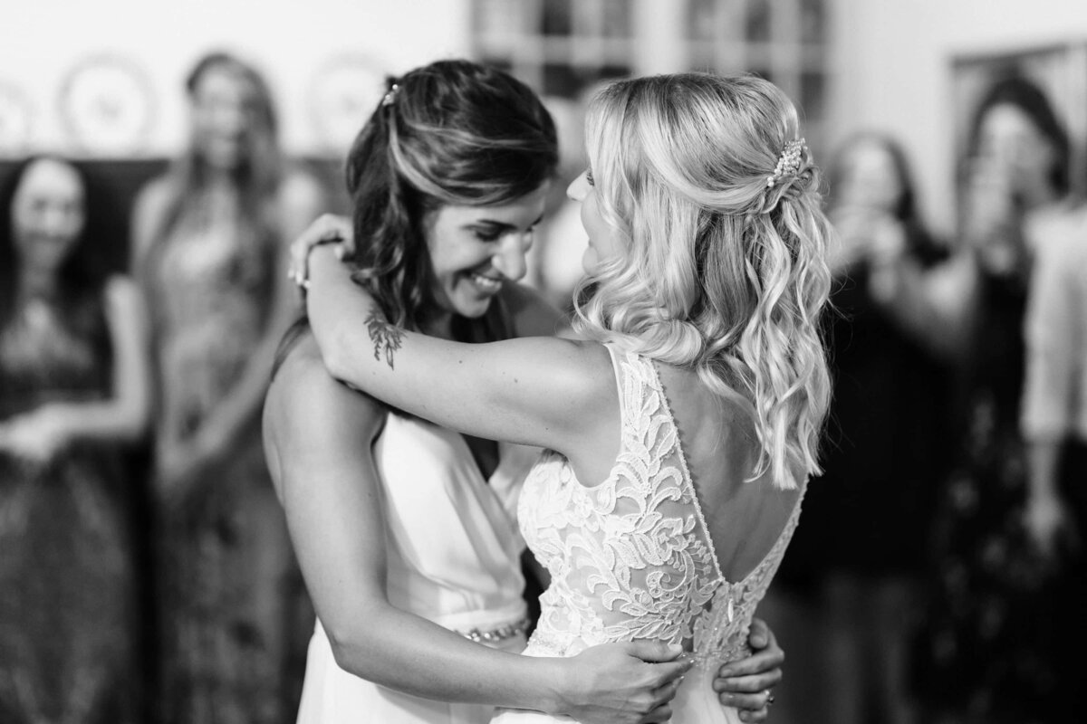 Two brides in black and white sharing their first dance