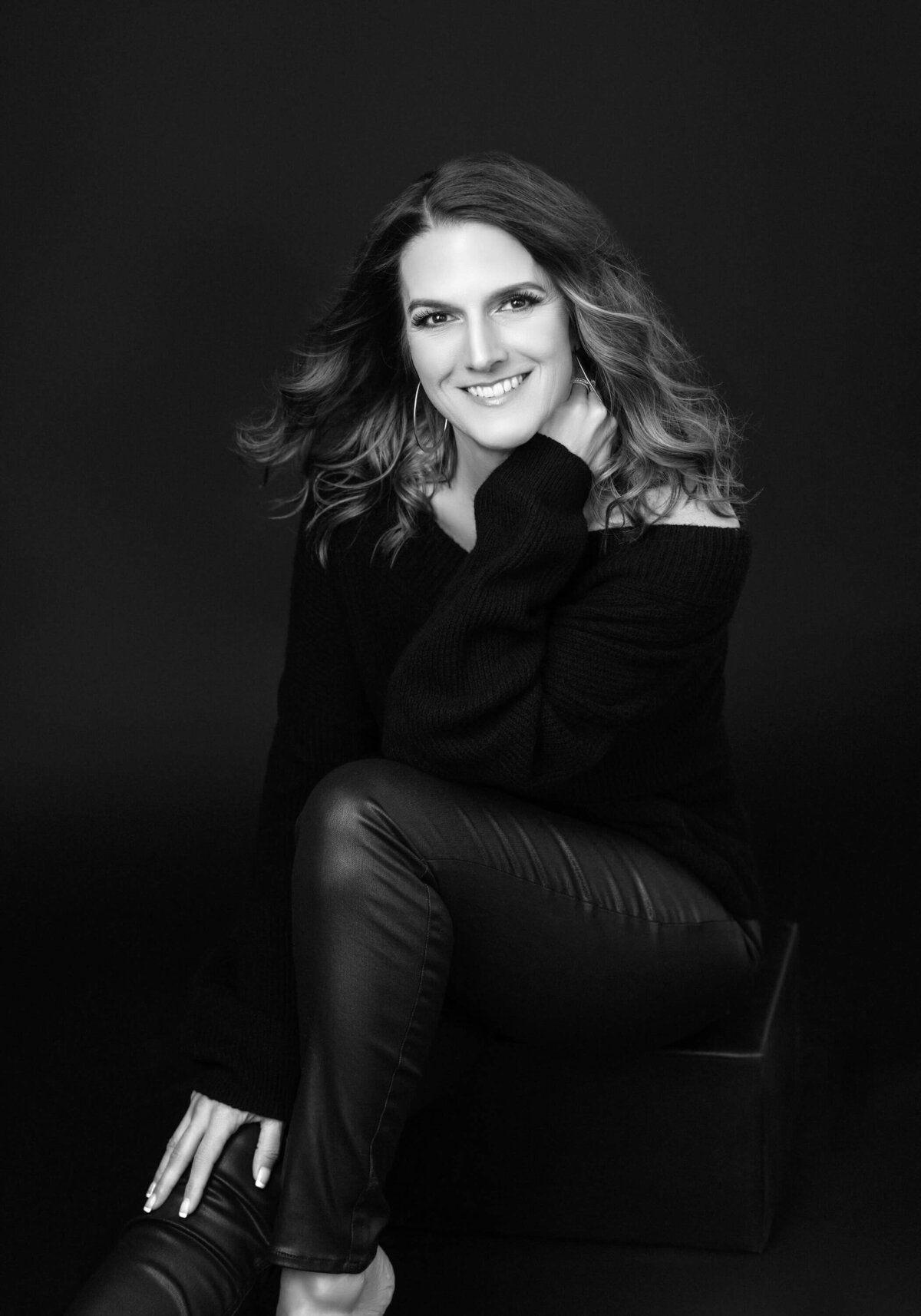 Empowered and sophisticated portrait of a woman with flawless styling and a confident gaze.
