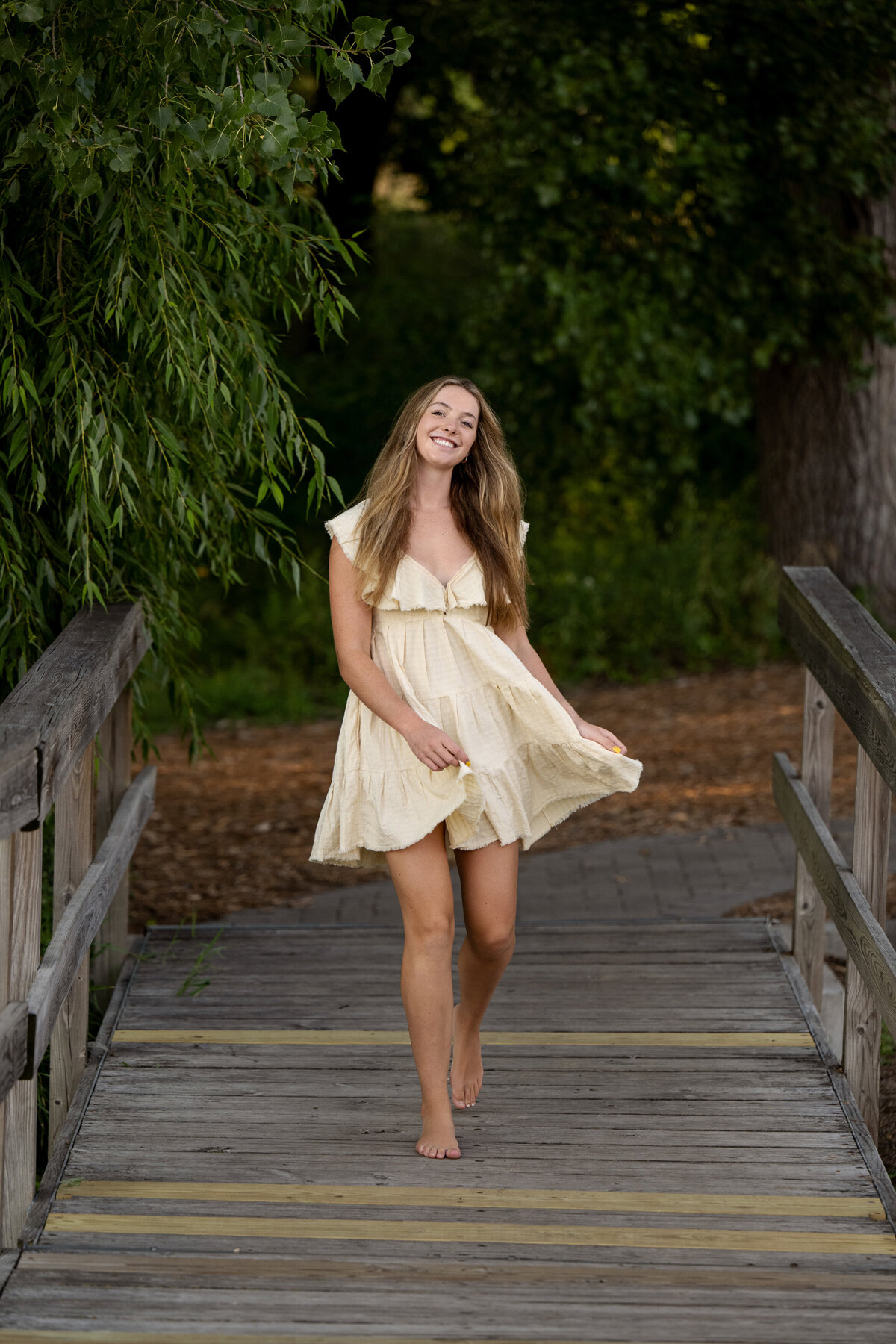 Orono Minnesota high school senior  photo of girl in white dress on dock in nature