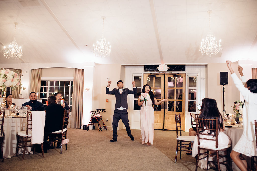 Wedding Photograph Of Groomsman And Bridesmaid Raising Their Hands Los Angeles