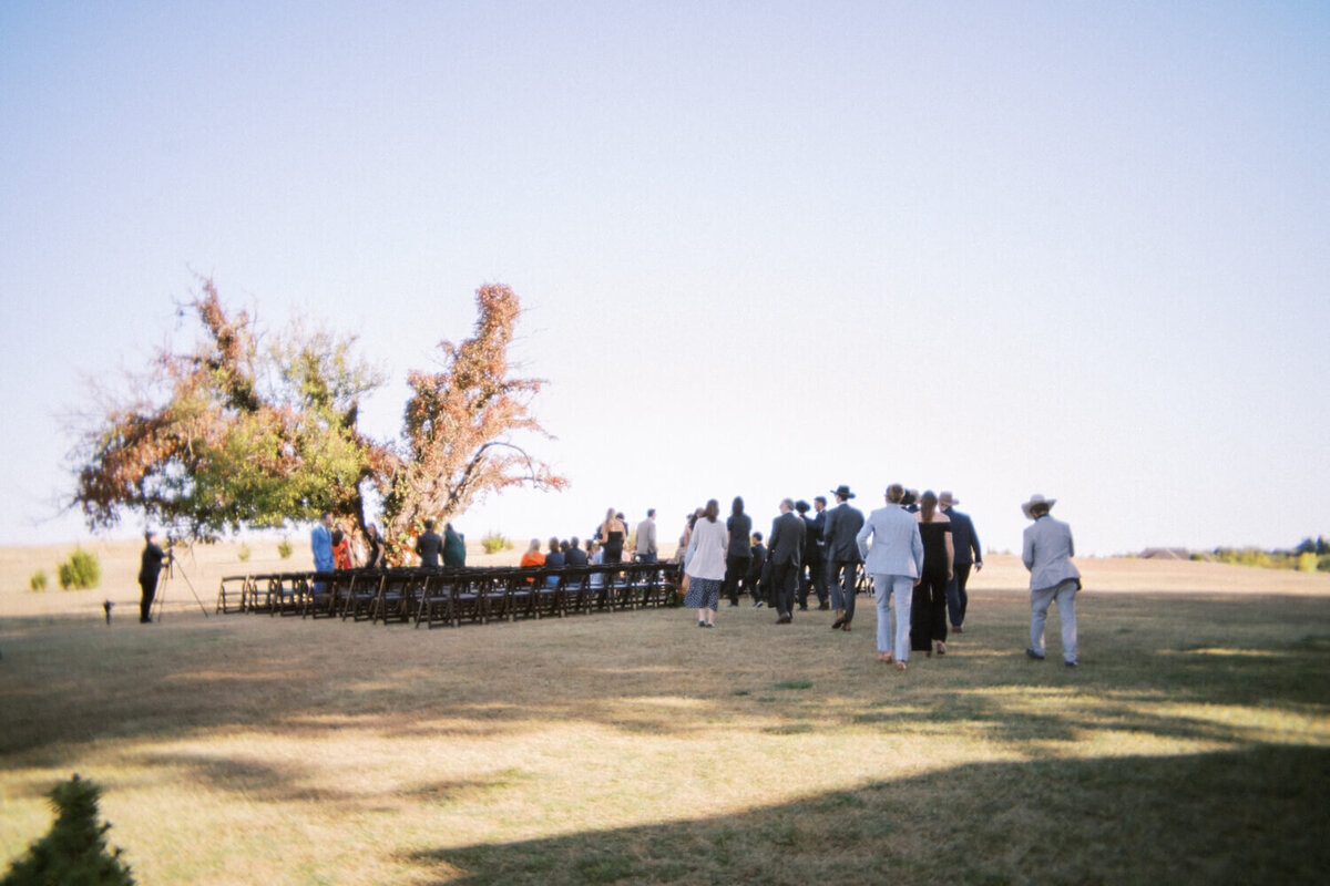 guests-walking-towards-ceremony-in-field