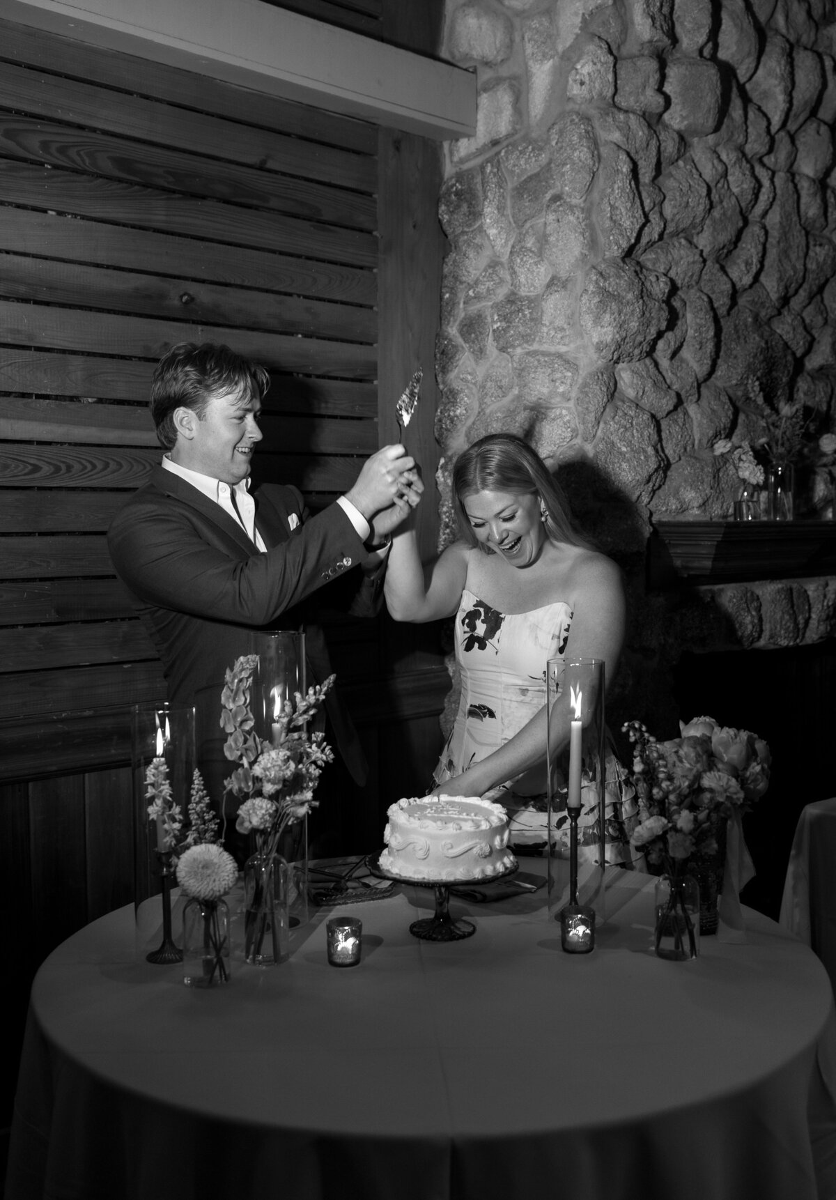 Bride and Groom cutting wedding cake taken by wedding film photography professional