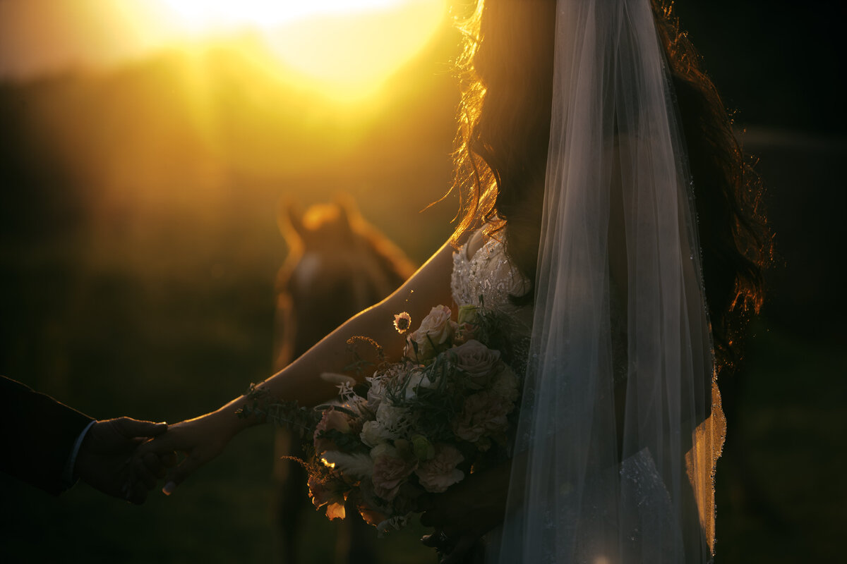 engaged couple hugging closely, girl whispering in his ear
