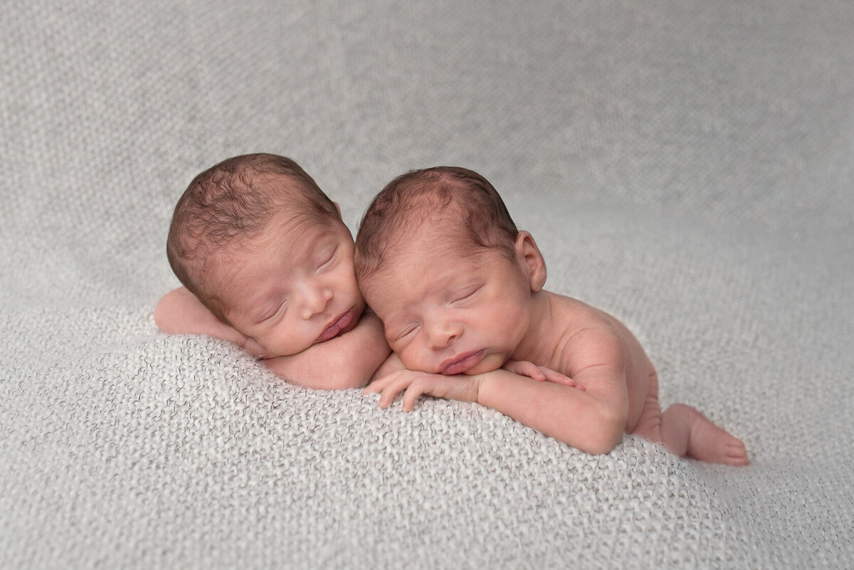 Chin on hands newborn twin photo  in Houston