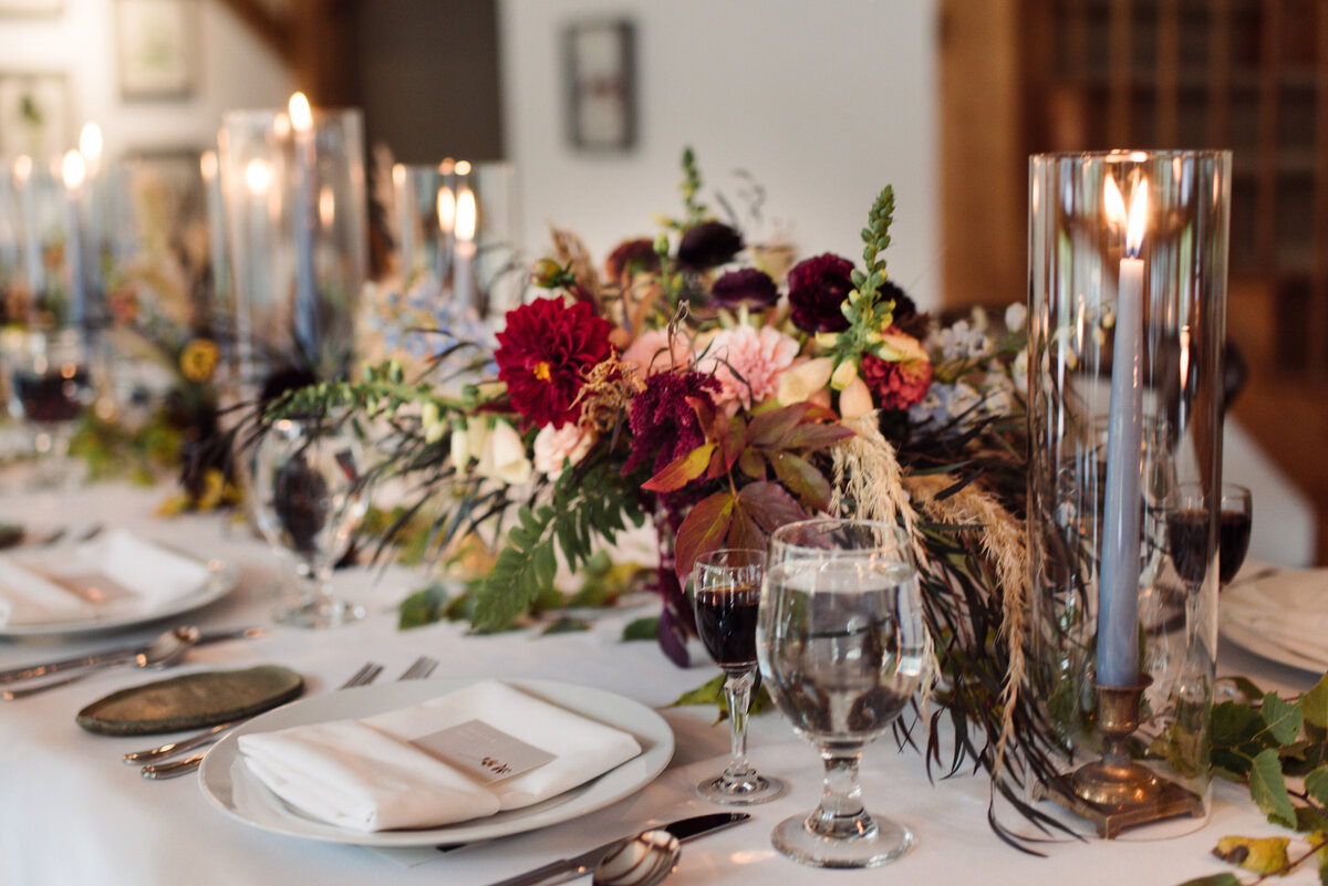 Blue candlesticks and lush fall florals at luxury wedding