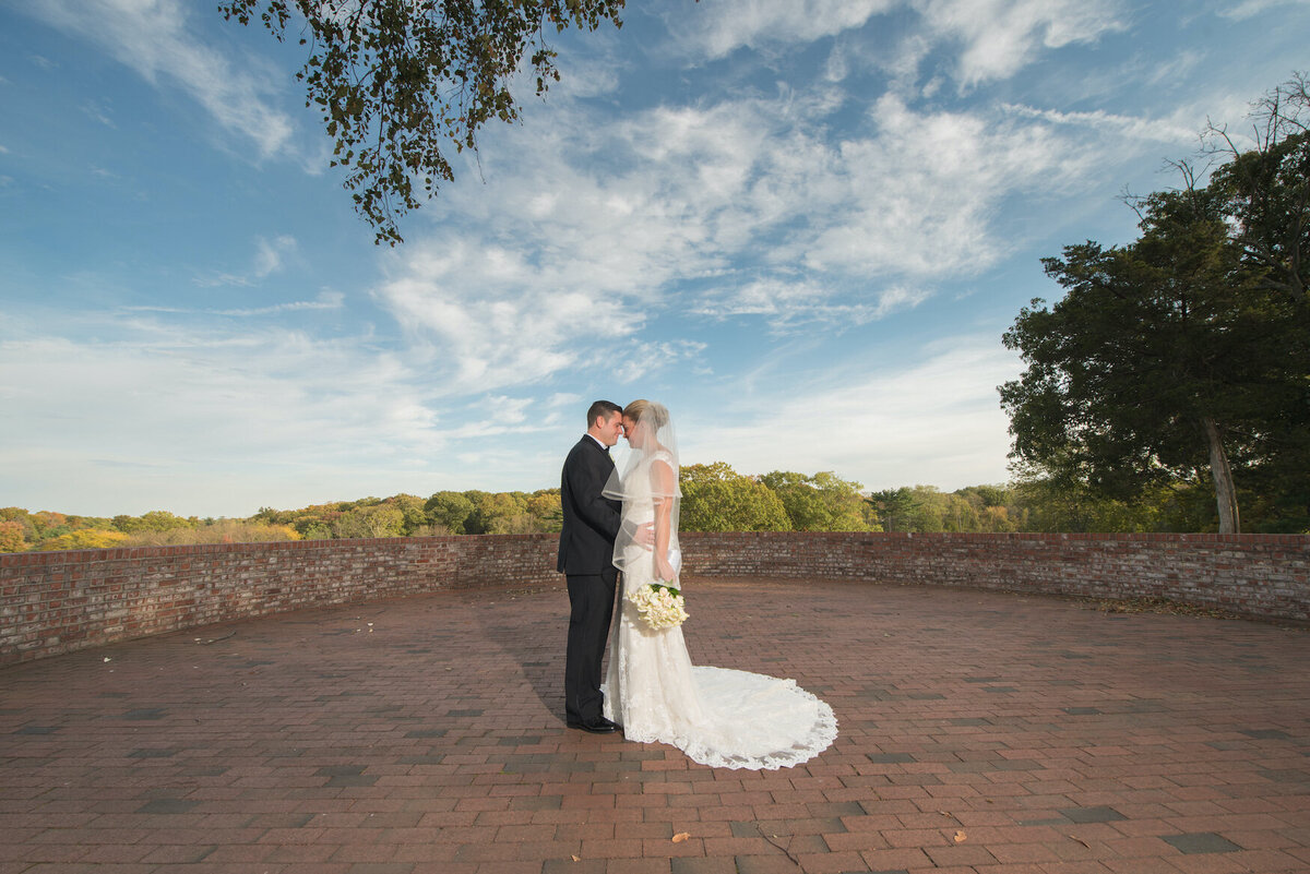 bride and groom staring into each other's eyes outside Heritage Club at Bethpage