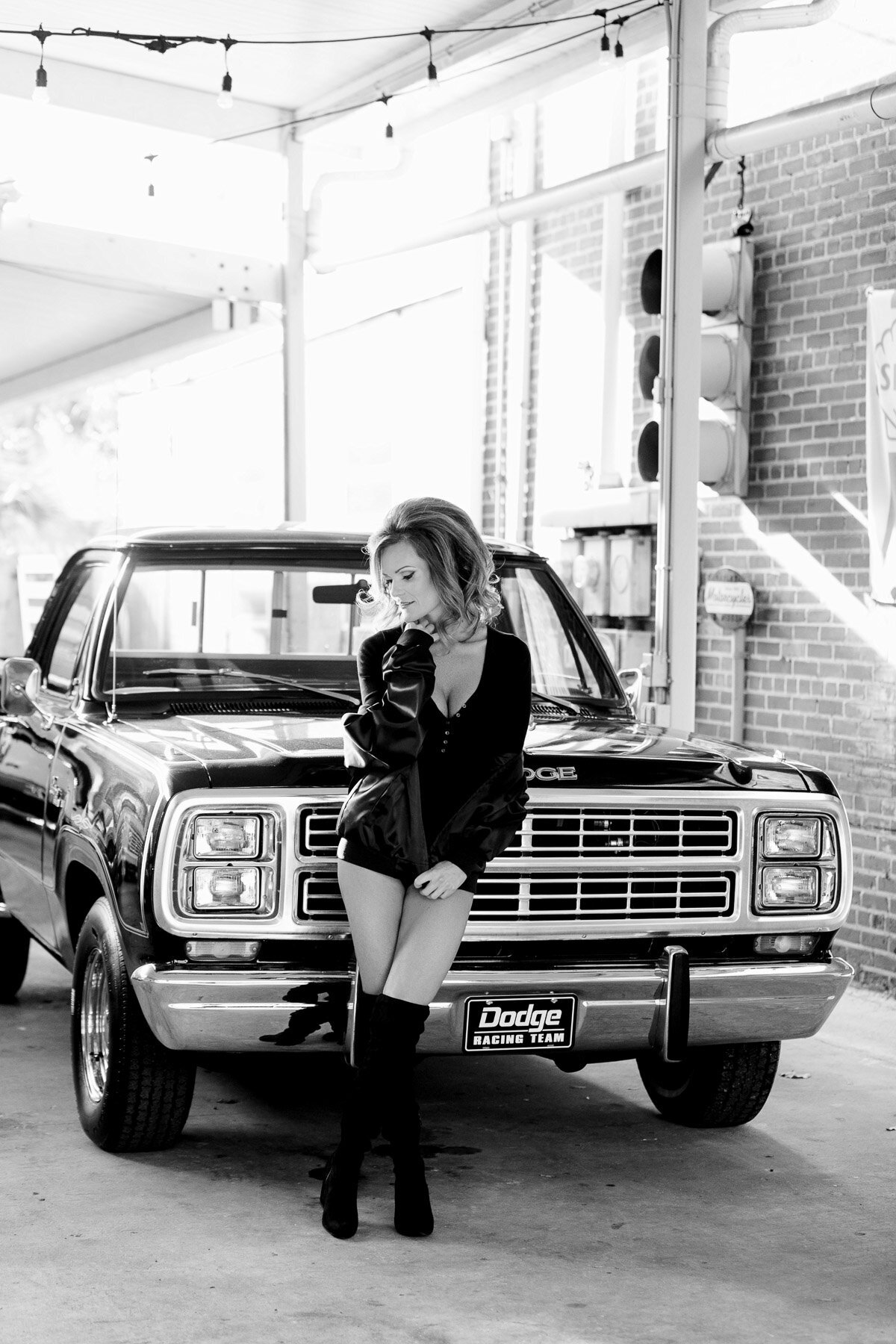 woman in black leather classic dodge truck