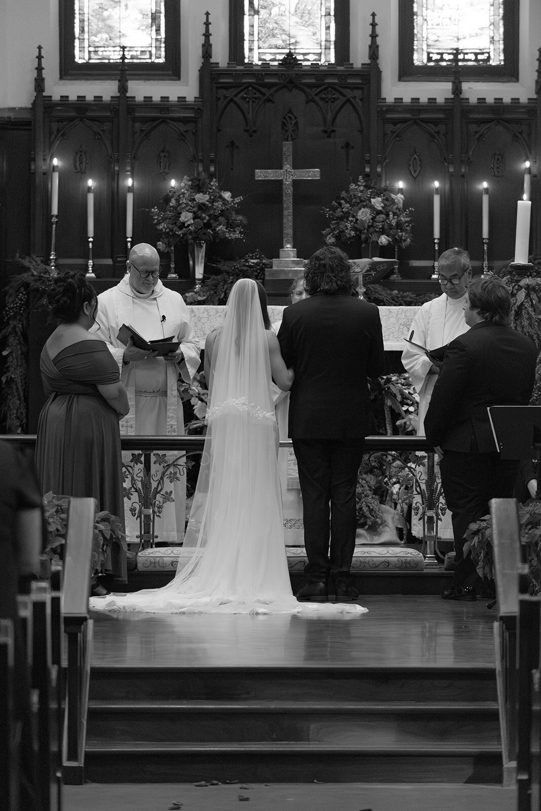 Black and White Portrait of Bride and groom photographed from behind during vow exchange at luxury San Antonio wedding