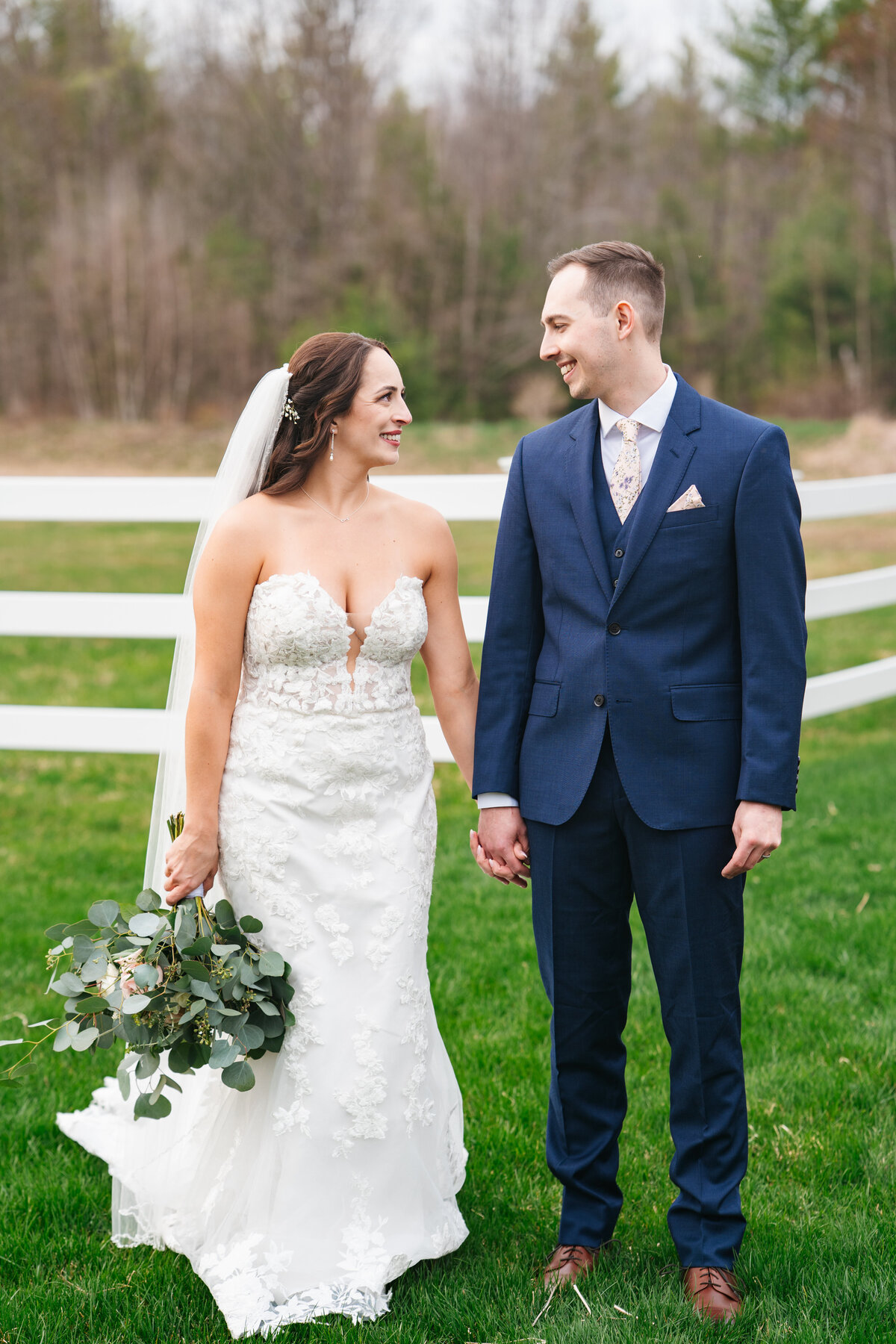 Elegant wedding flat lay with rings, florals, and invitations