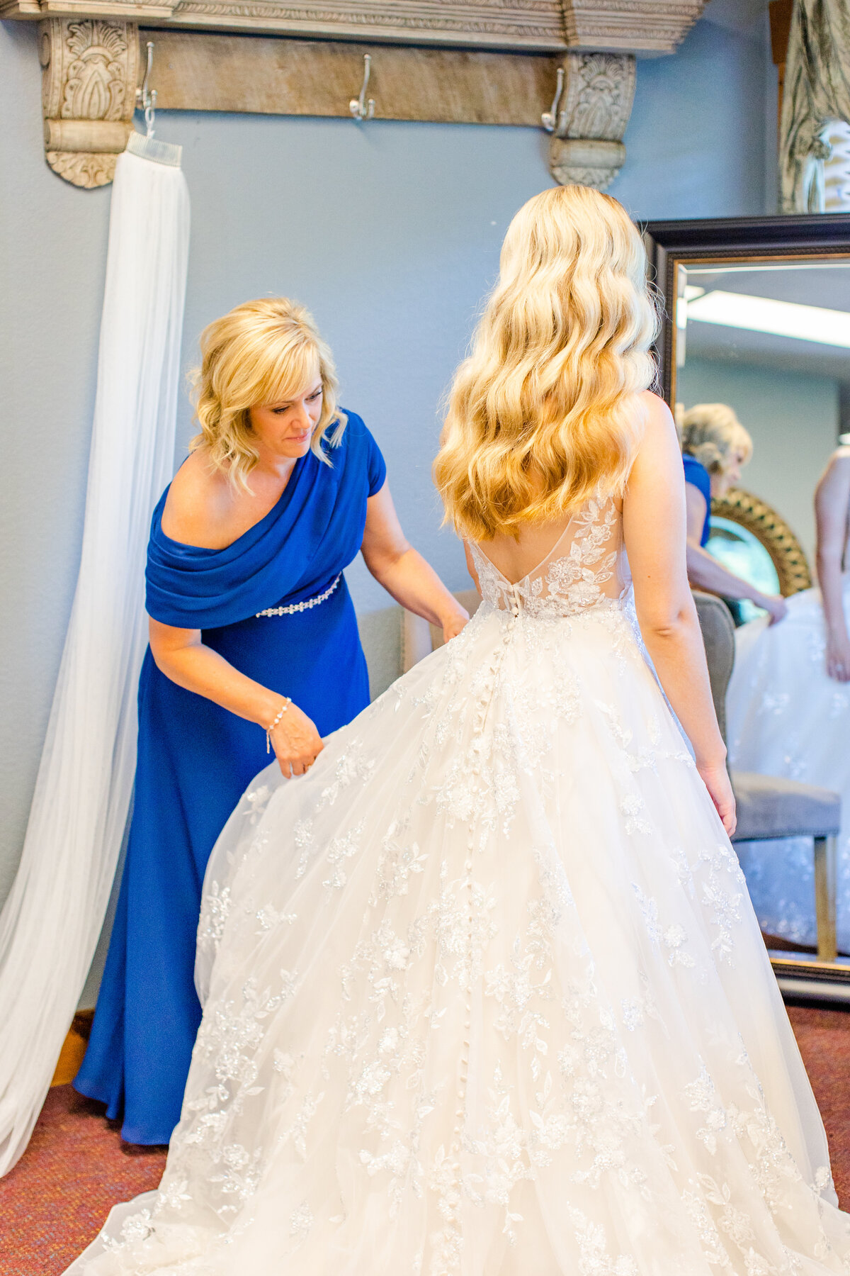 Bride and her mom fluffing her dress at Laurel Ridge Country Club