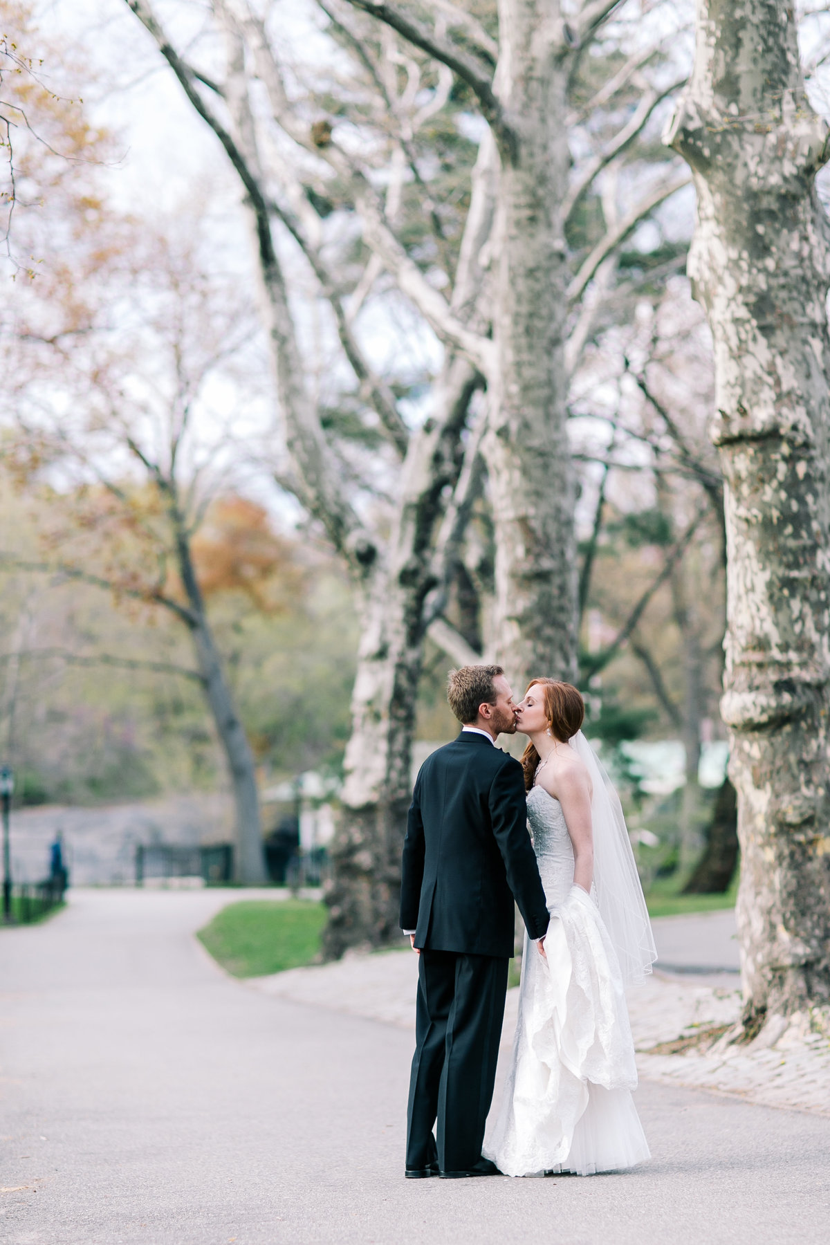 bride and groom kissing in central park