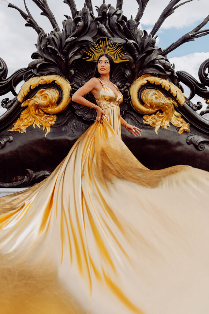 Elegant Paris portrait session at Alexandre III bridge - woman in gold dress and crown against golden arches during luxury photoshoot