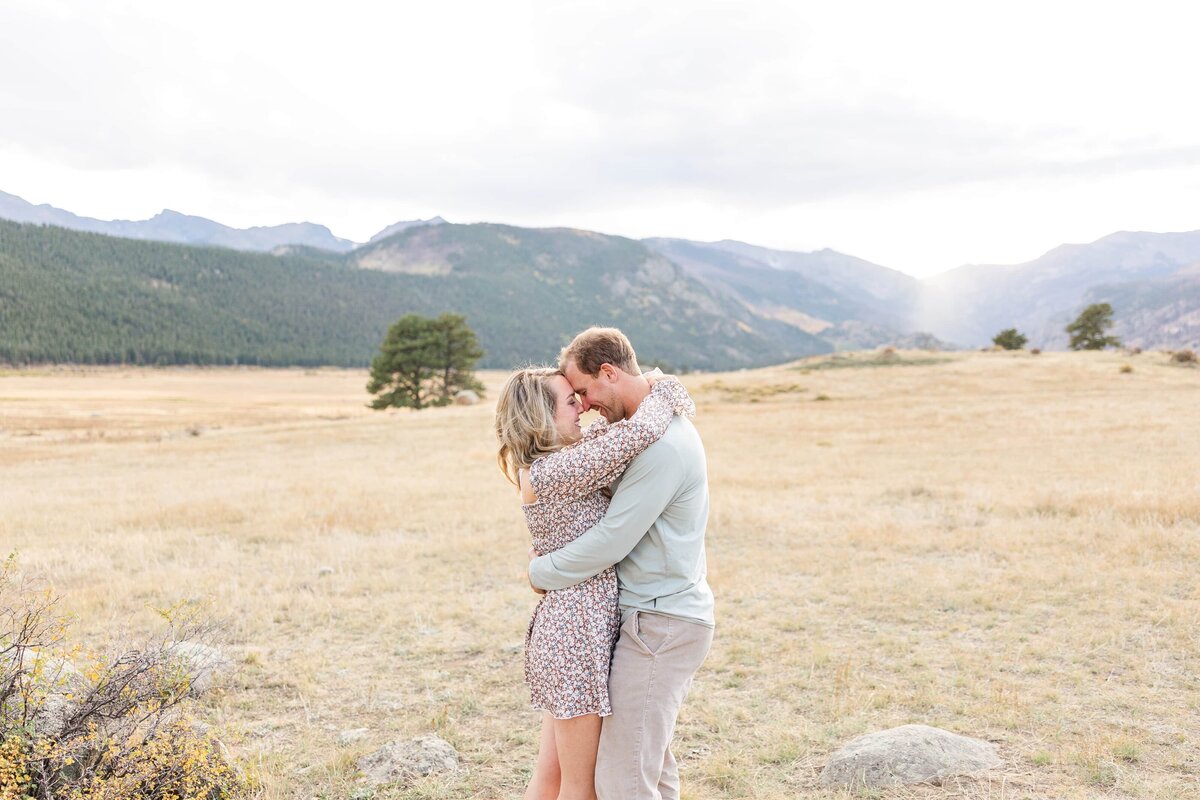 Couple snuggle in field