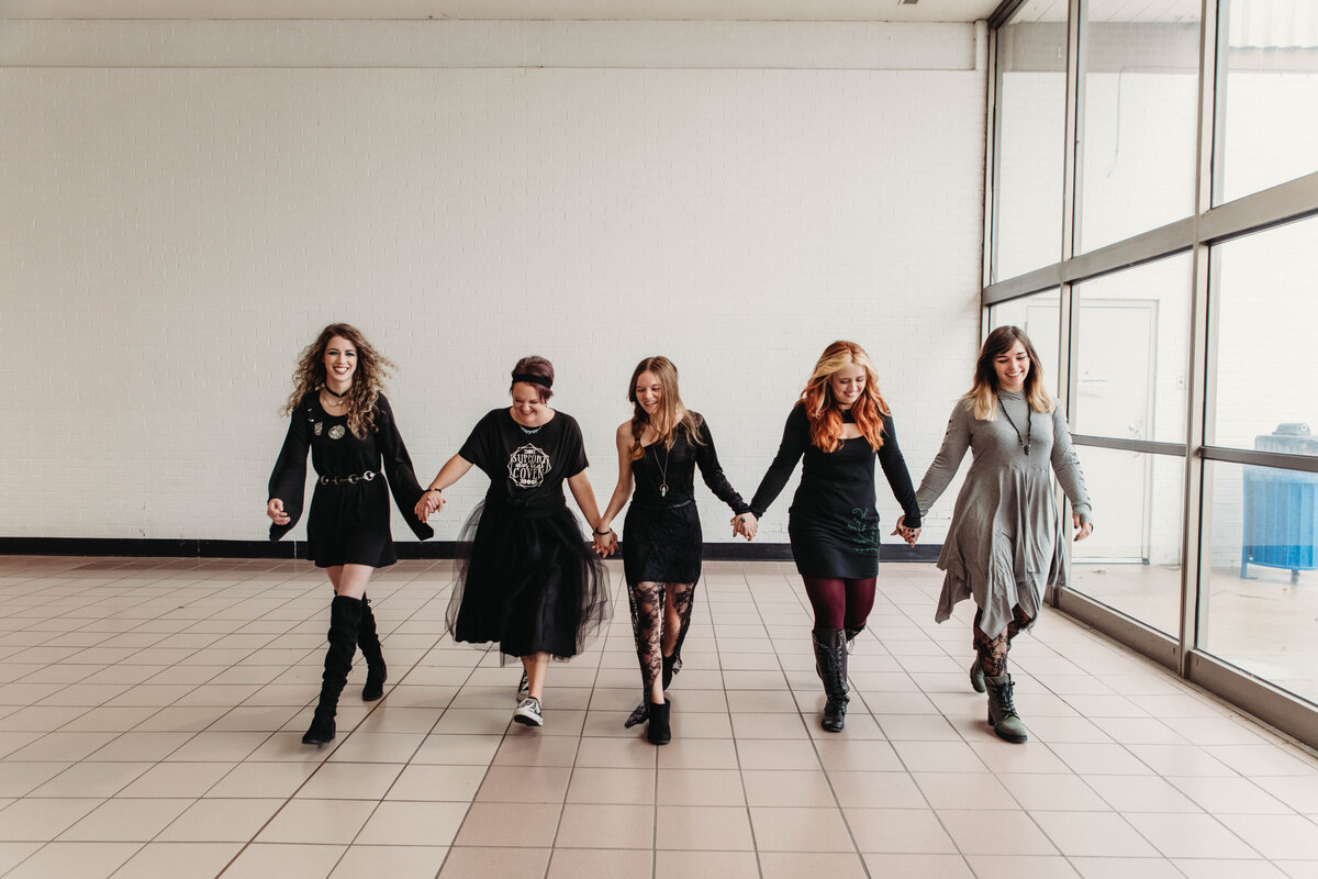 Clothing designer and models walk for new witchy clothing line in Elyria mall.