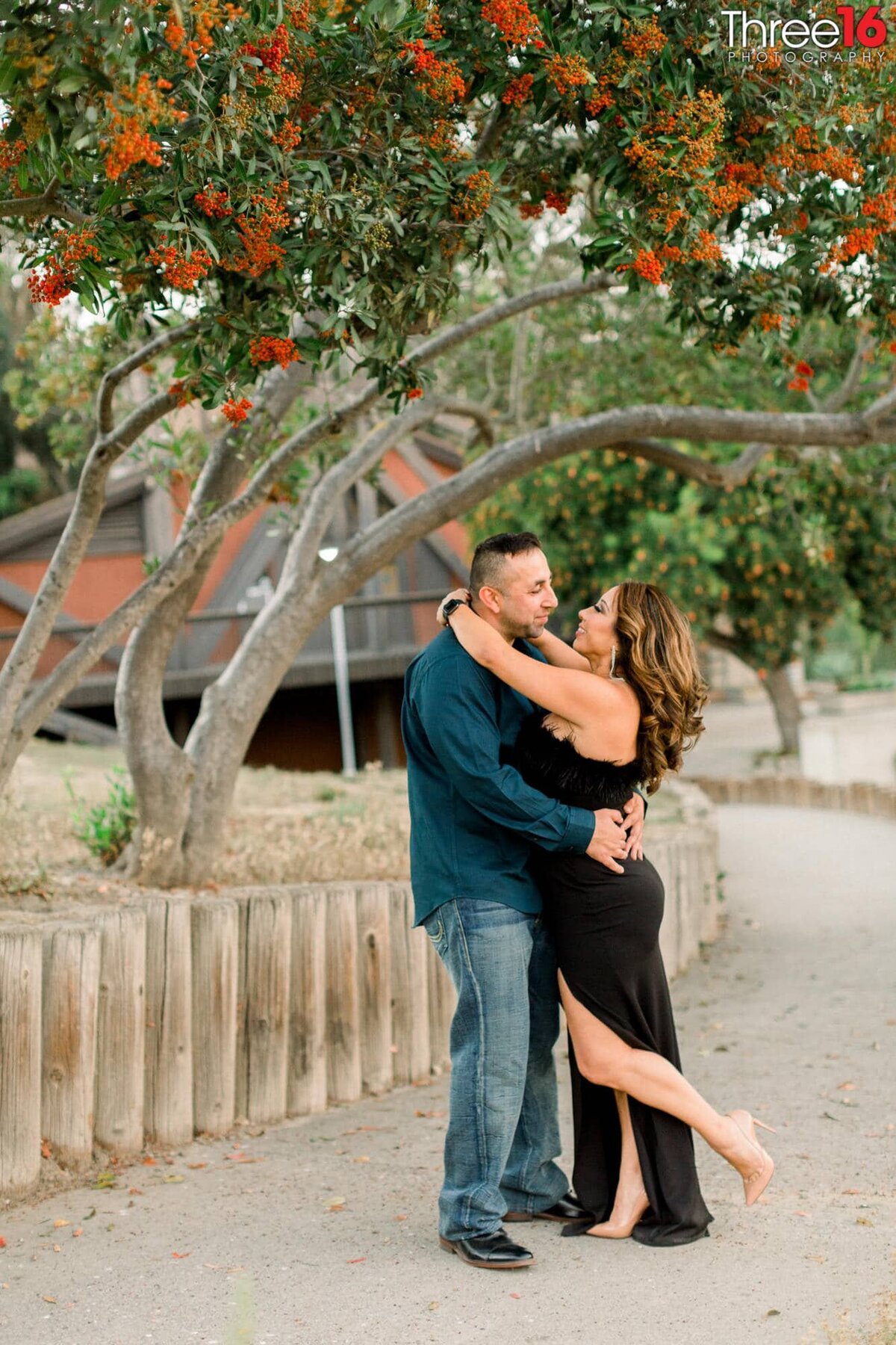 Engaged couple embrace just before they kiss during photo session