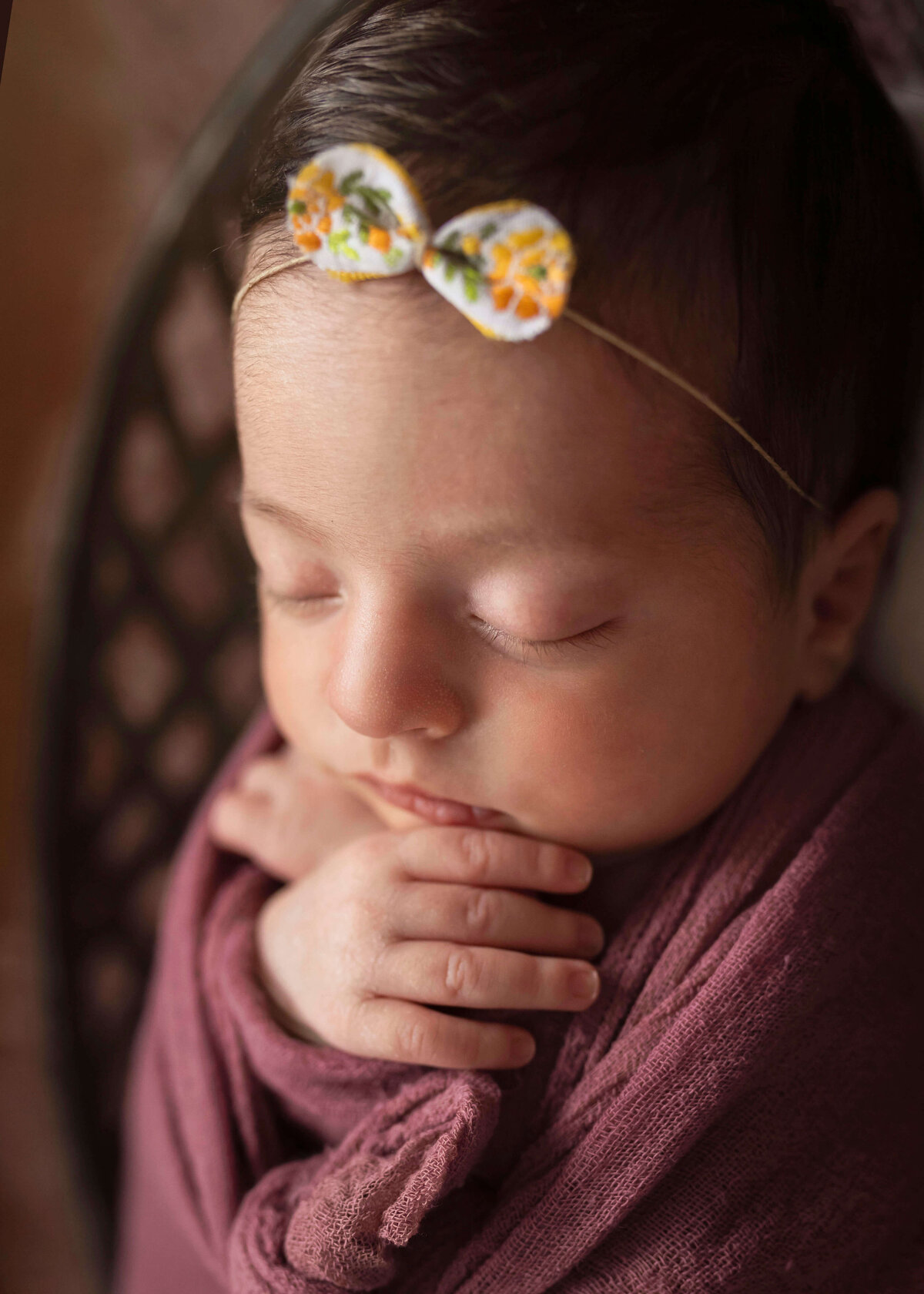 NJ Newborn photographer poses baby's hands by her face