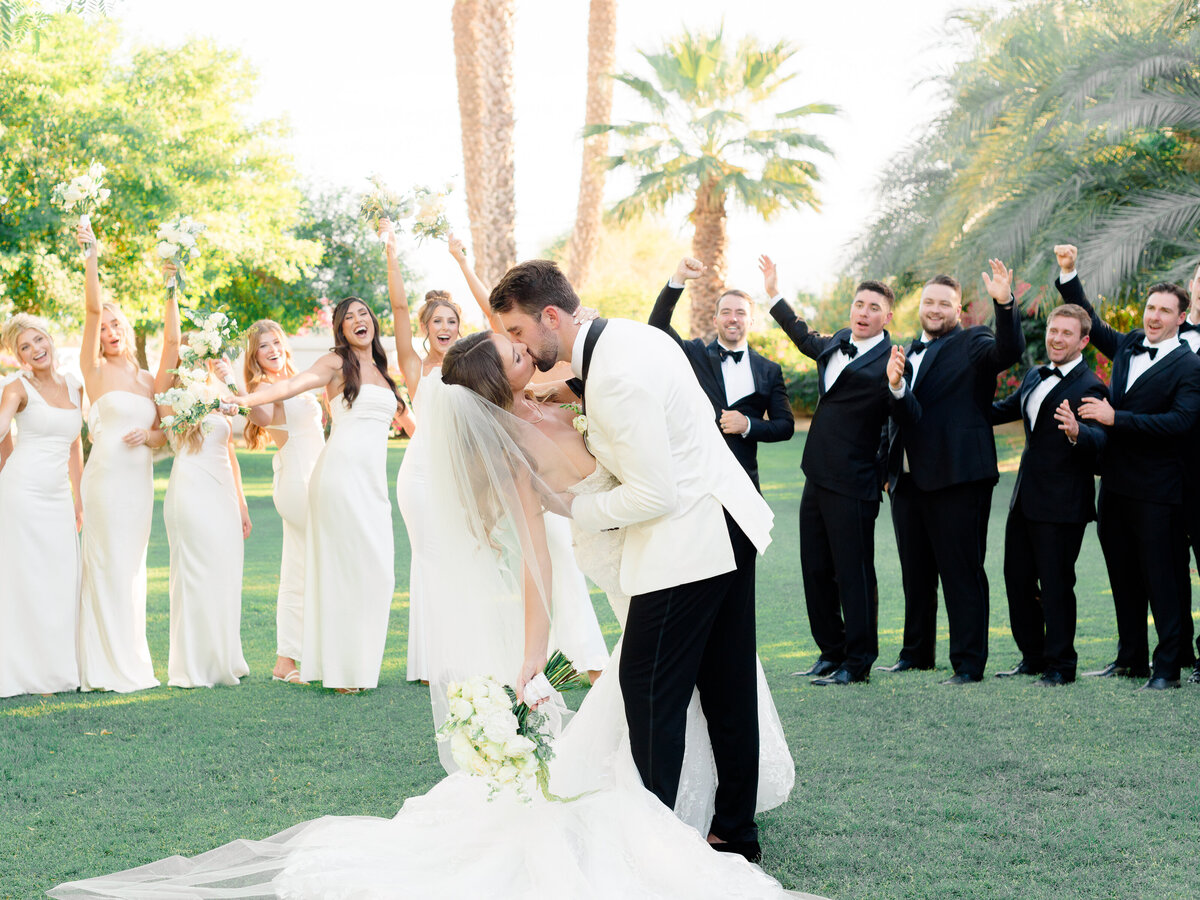 tara-tyler-wedding-party-cheer-kiss-bougainvilla-estate.jpg