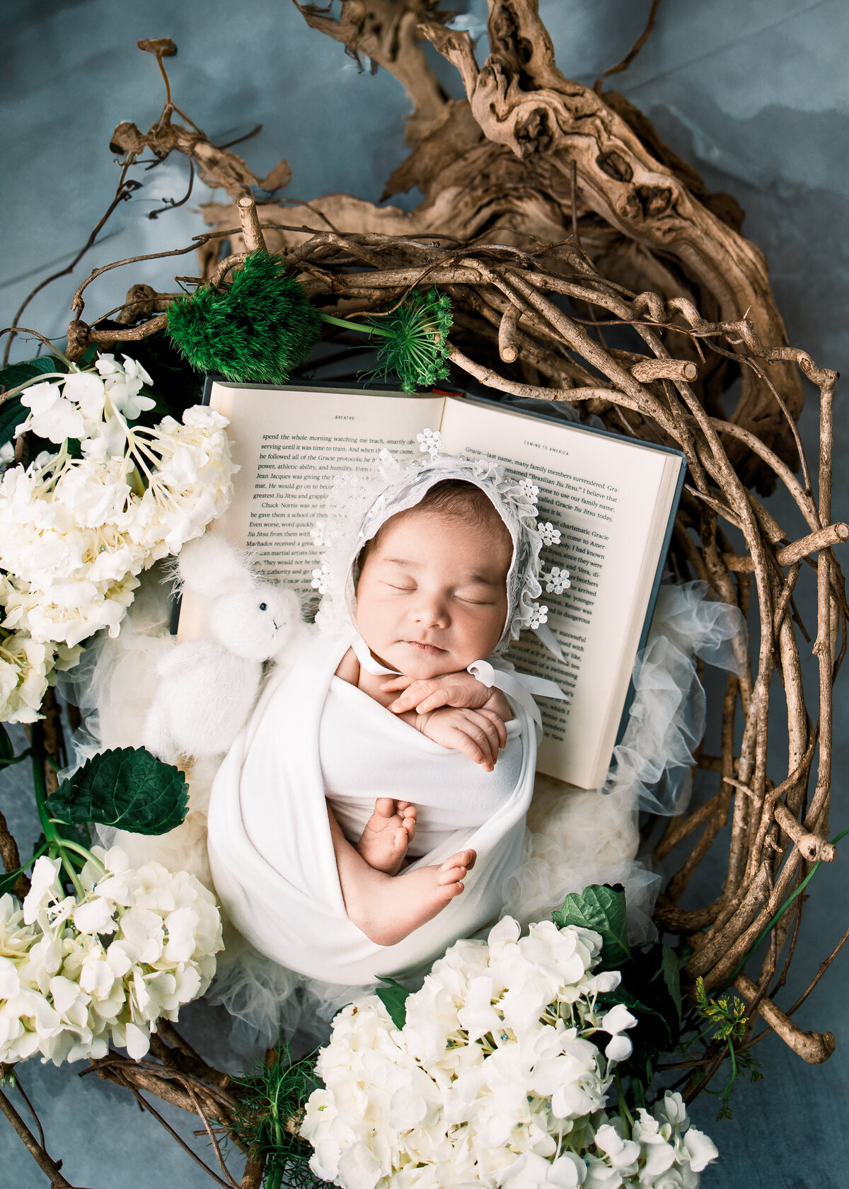 baby girl newborn photo in a natural vine basket, next to bunny