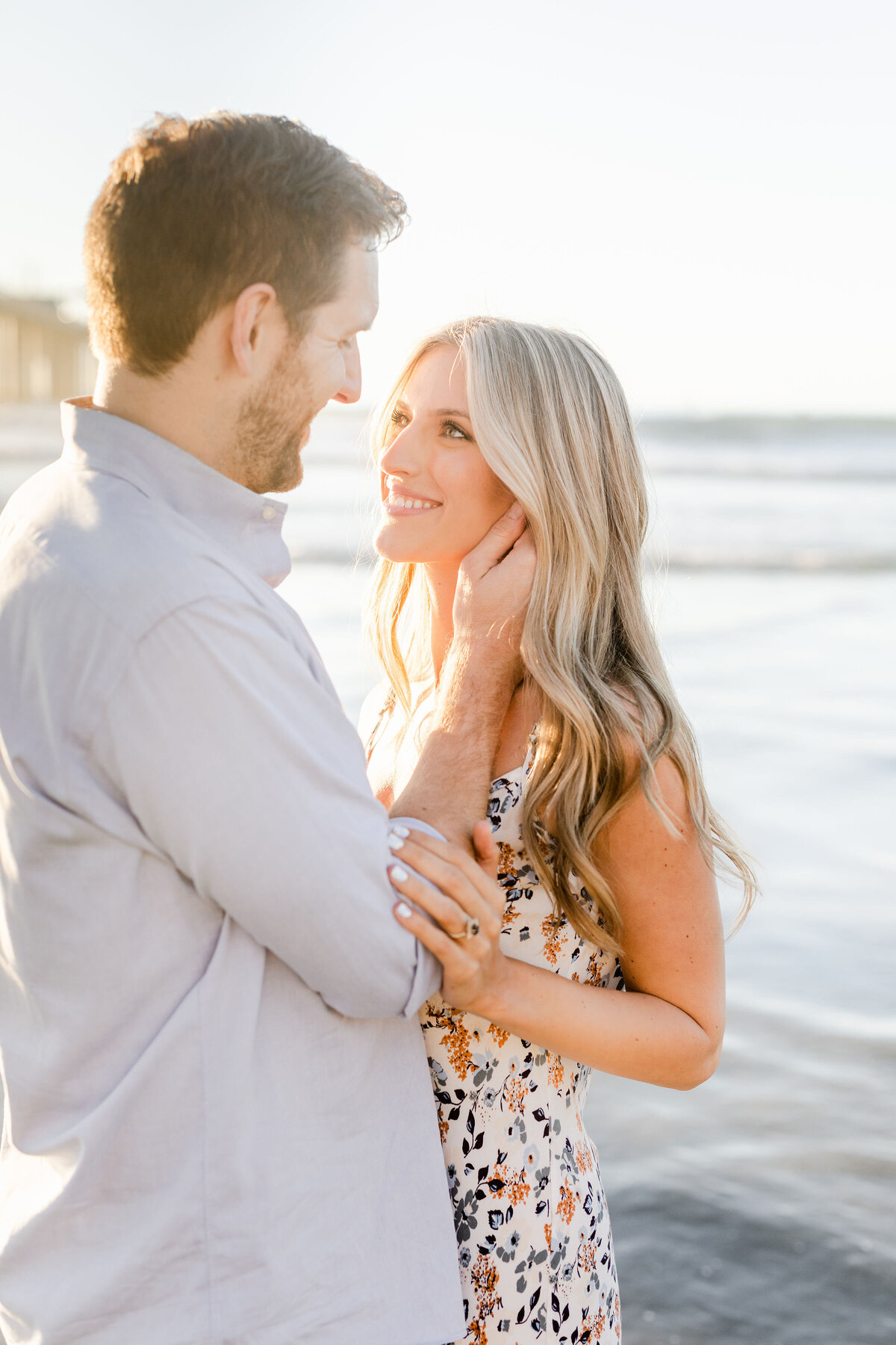 Couple running on the beaches of La Jolla by Lisa Riley Photography