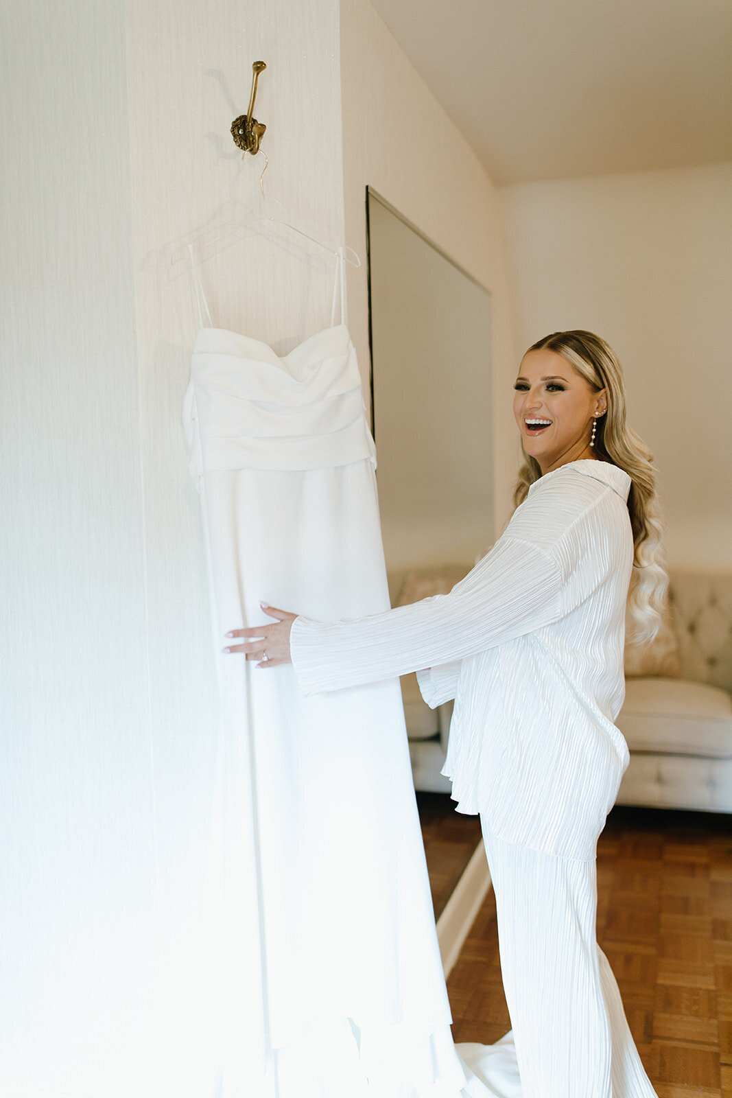 bride-with-dress-hanging-in-bridal-suite-saint-clements-castle