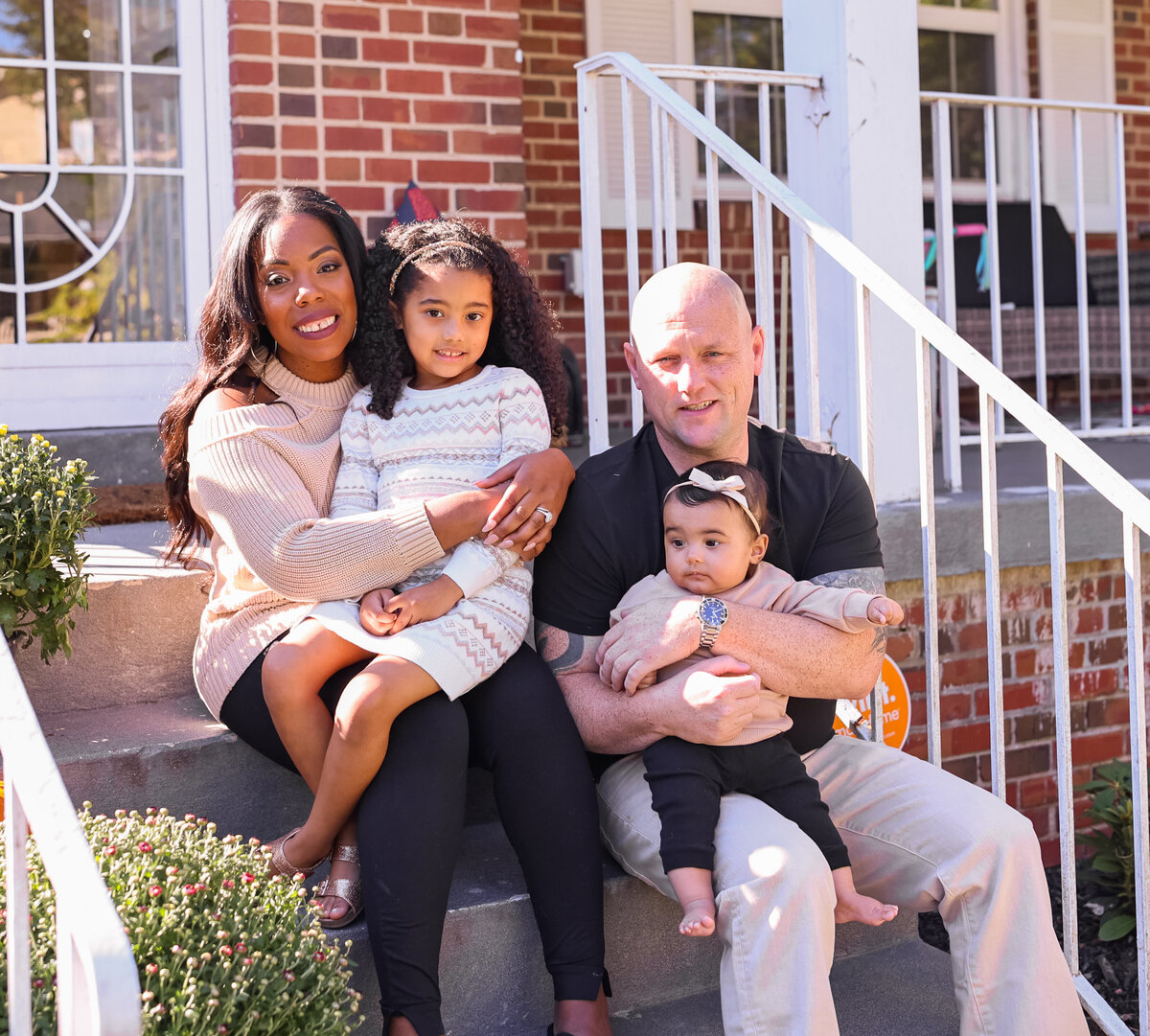 family sitting on front porch steps in Columbus Georgia by family photographer Amanda Richardson Photography