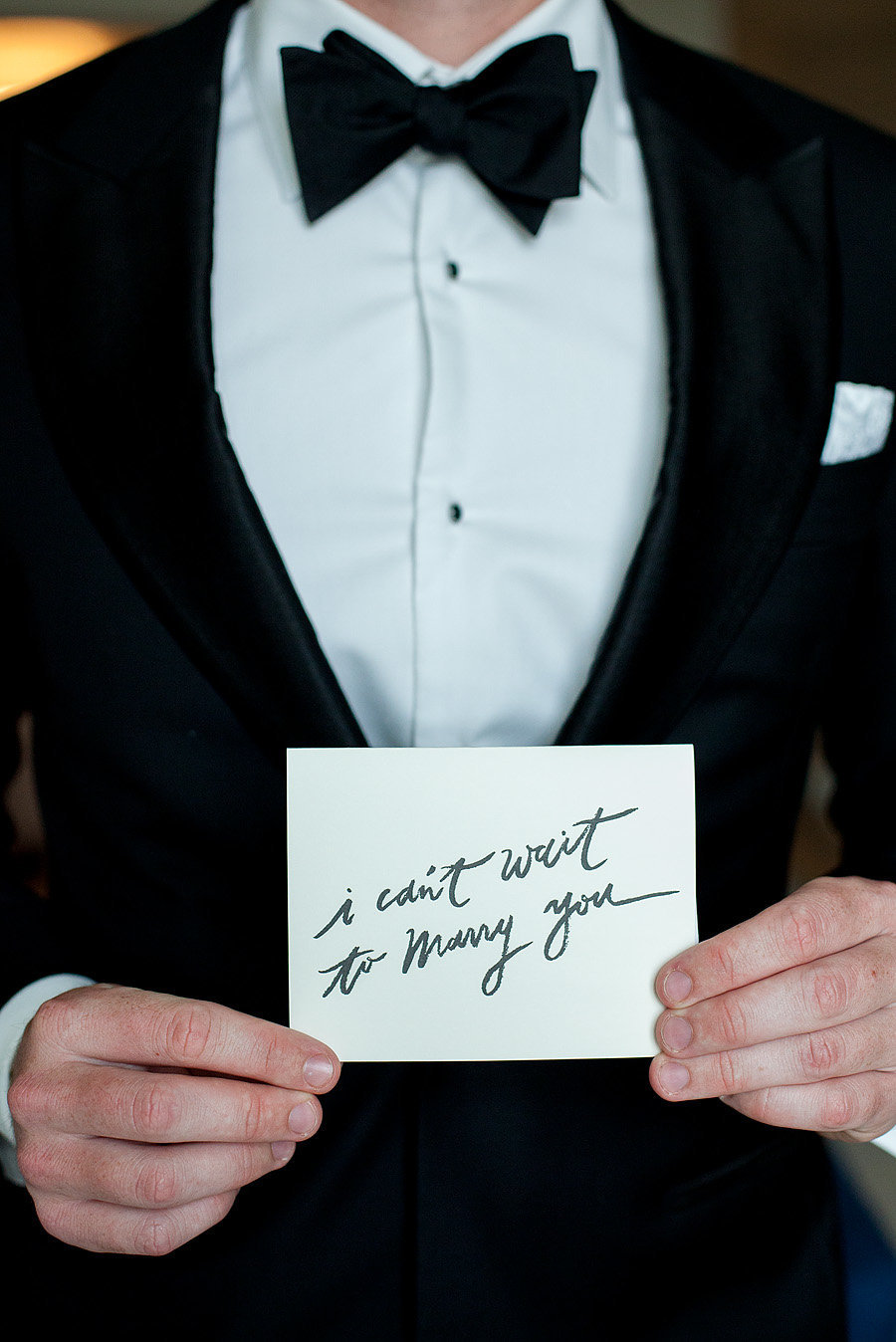 groom holding card that says i can't wait to marry you, flagler museum wedding