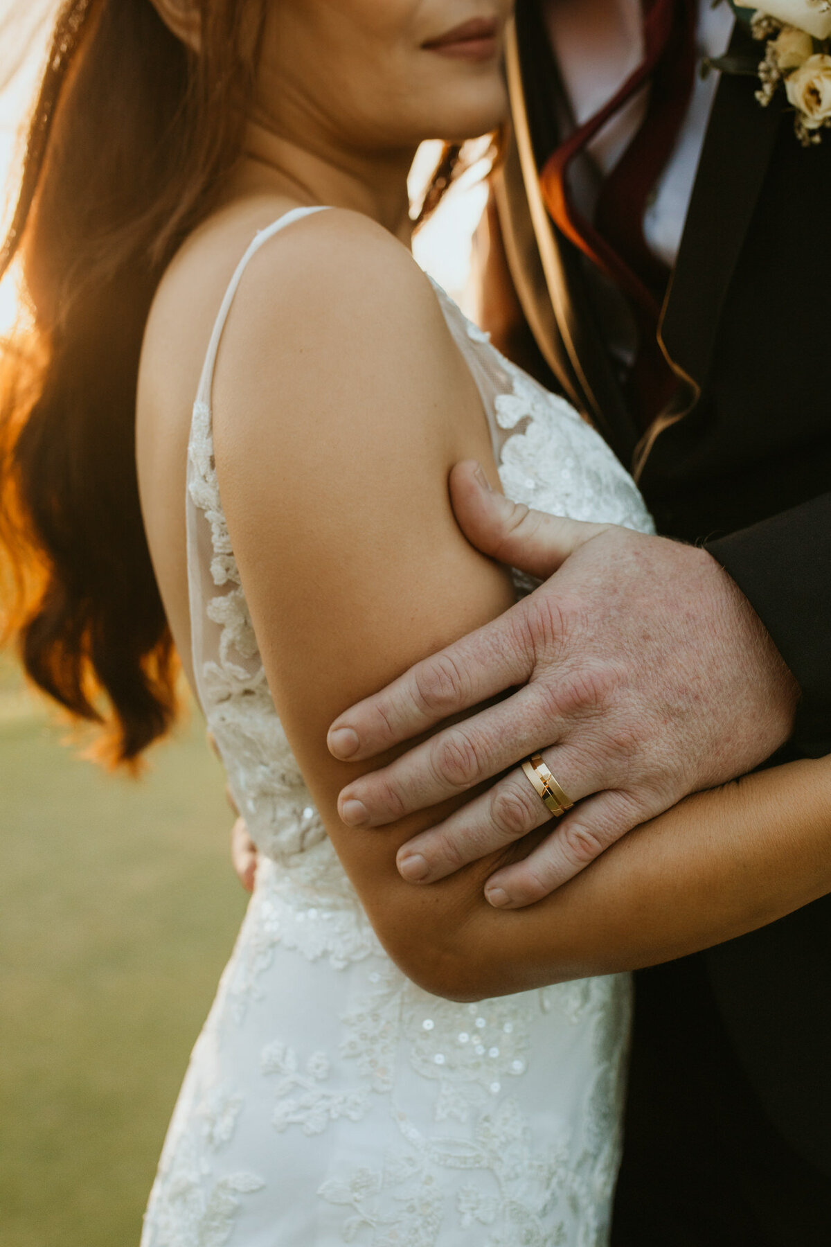 A groom's hand holding his bride gently during the portrait session. 