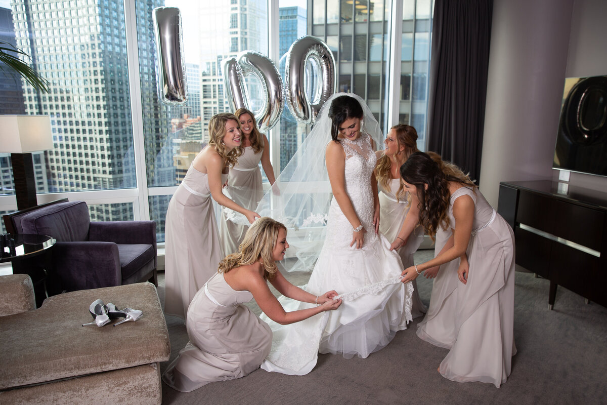 A bride and bridesmaids getting ready for a wedding with balloons in Chicago.