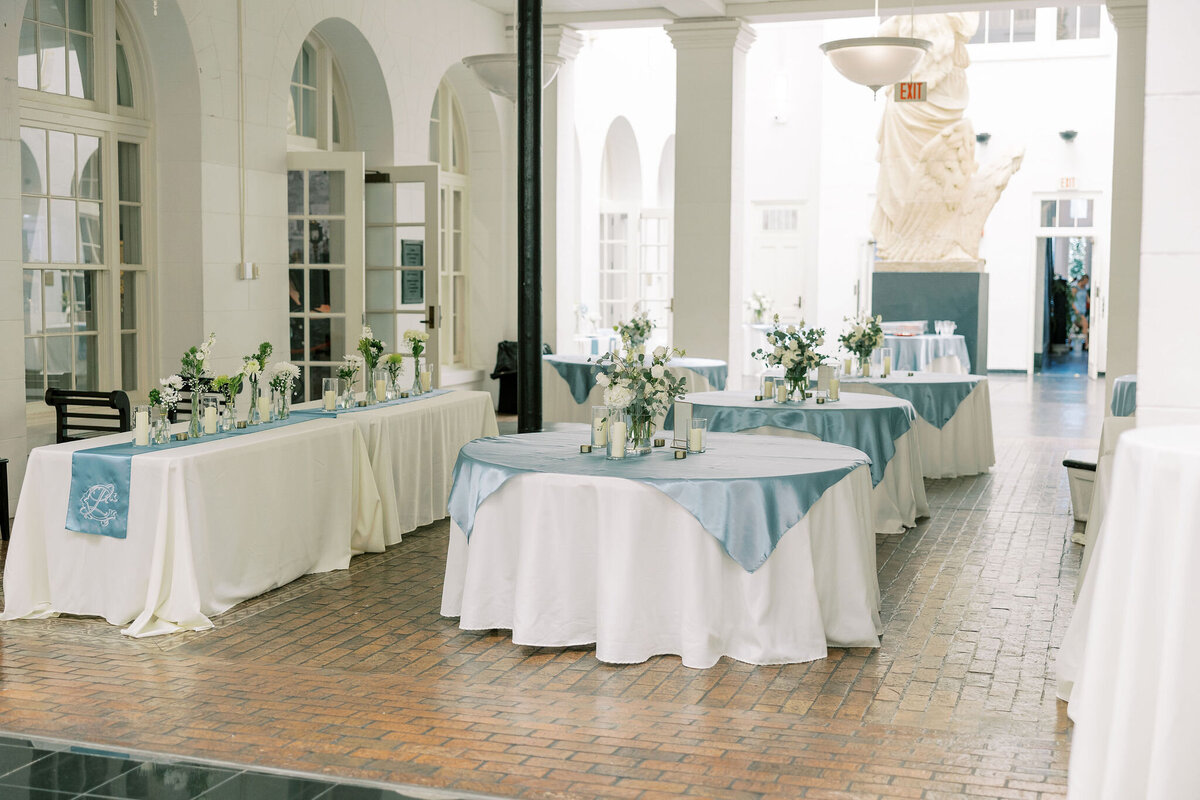tables decorated in a blue and white theme for a wedding